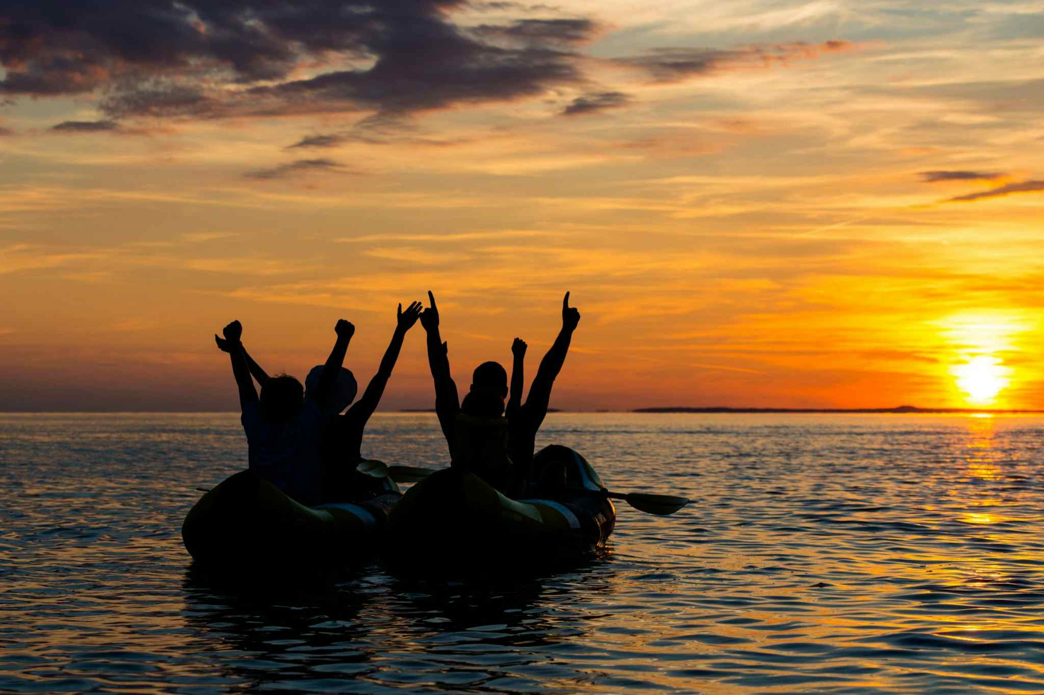 Athens Kayaking, Greece. Photo: Canva - https://www.canva.com/photos/MAEErehWEv4-family-rejoicing-in-sea-kayaks-at-sunset/