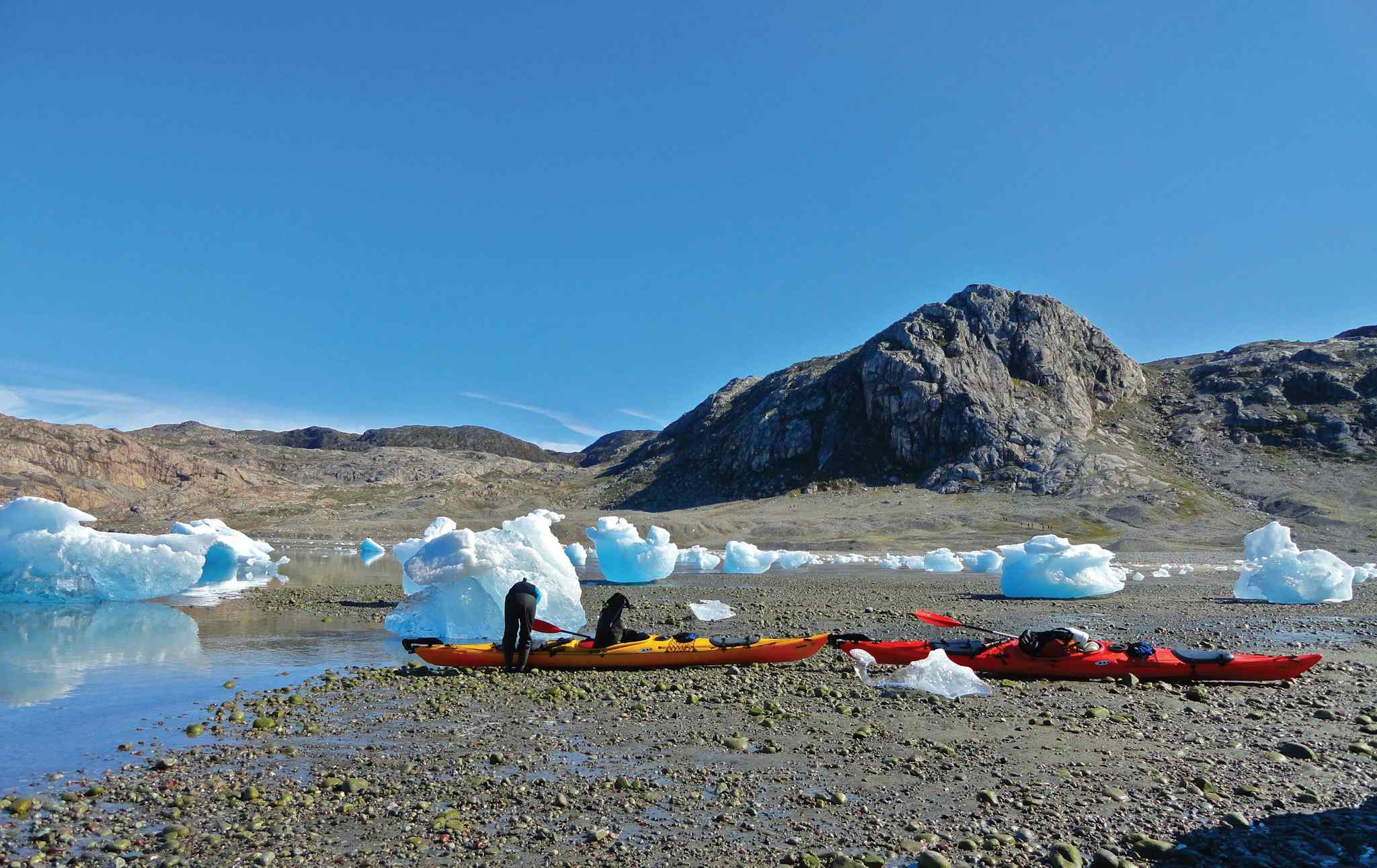 Pulling up kayaks among icebergs, Greenland. Photo: Host/Tasermiut