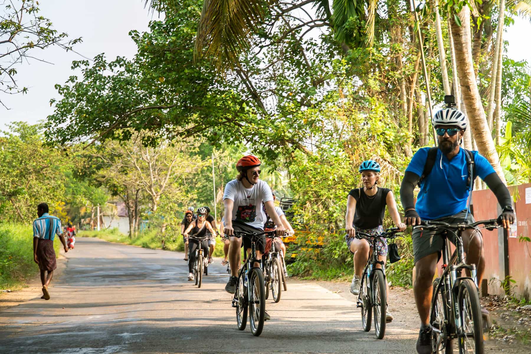 Group of cyclists on rural roads in Kerala, India.