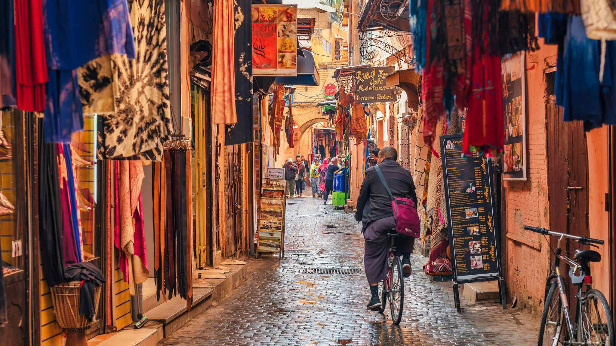 A cyclist cycles through the backstreets of Marrakesh, Morocco. 