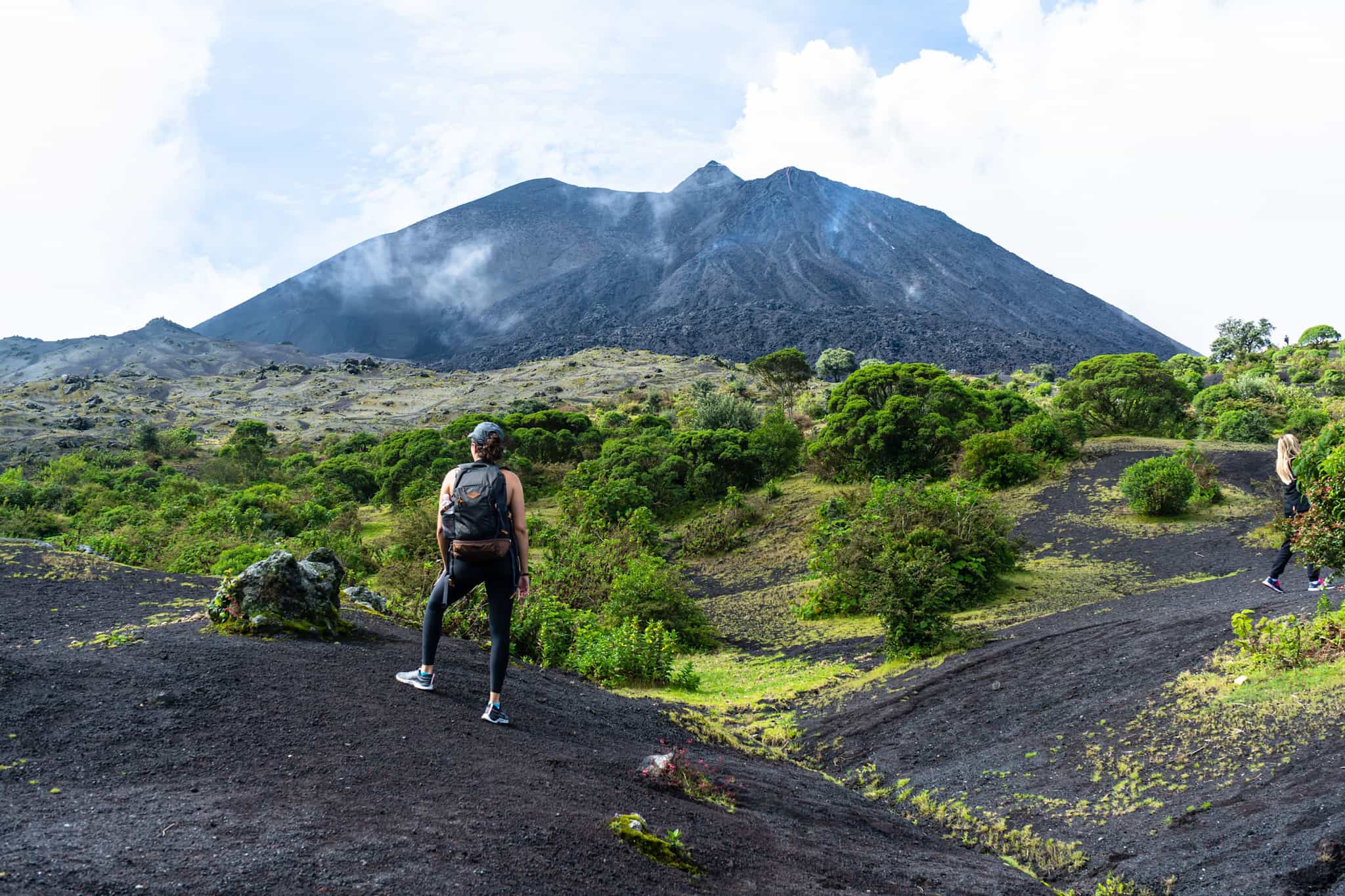 Female hikers observe the top of the Pacaya volcano in Guatemala.