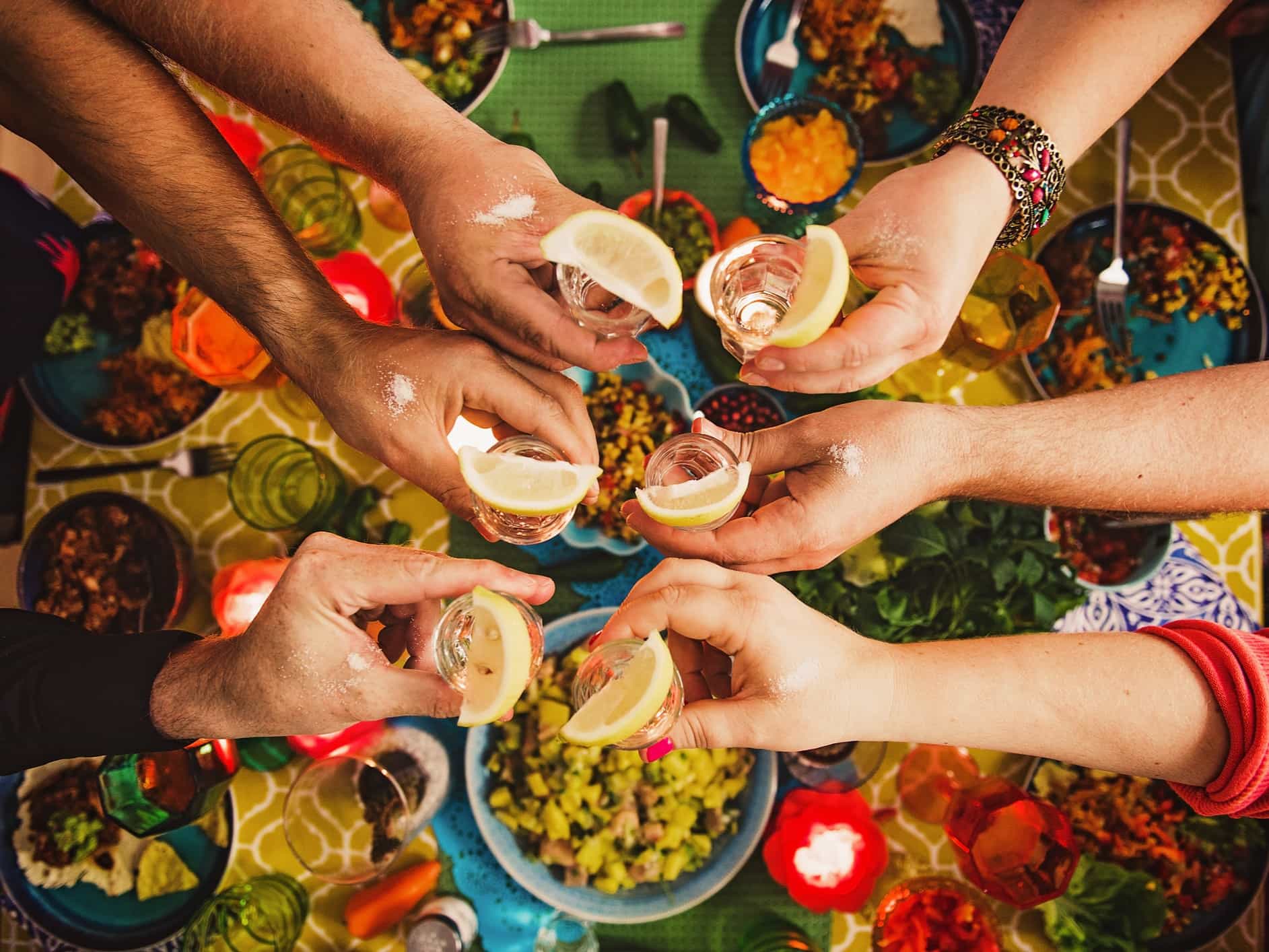 A group enjoying some tequilas and Mexican food.