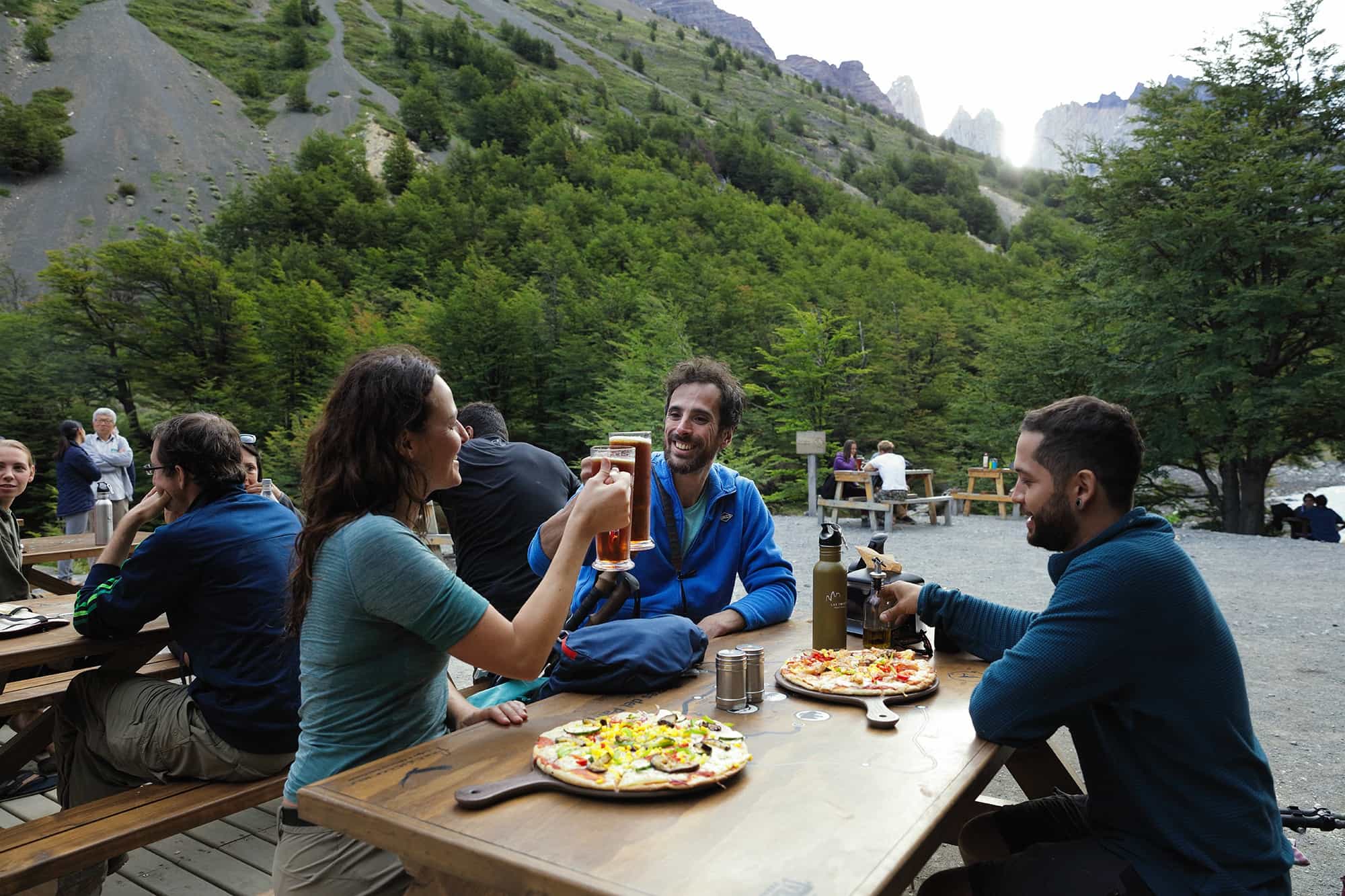Hikers enjoying a meal outside at Chileno camp