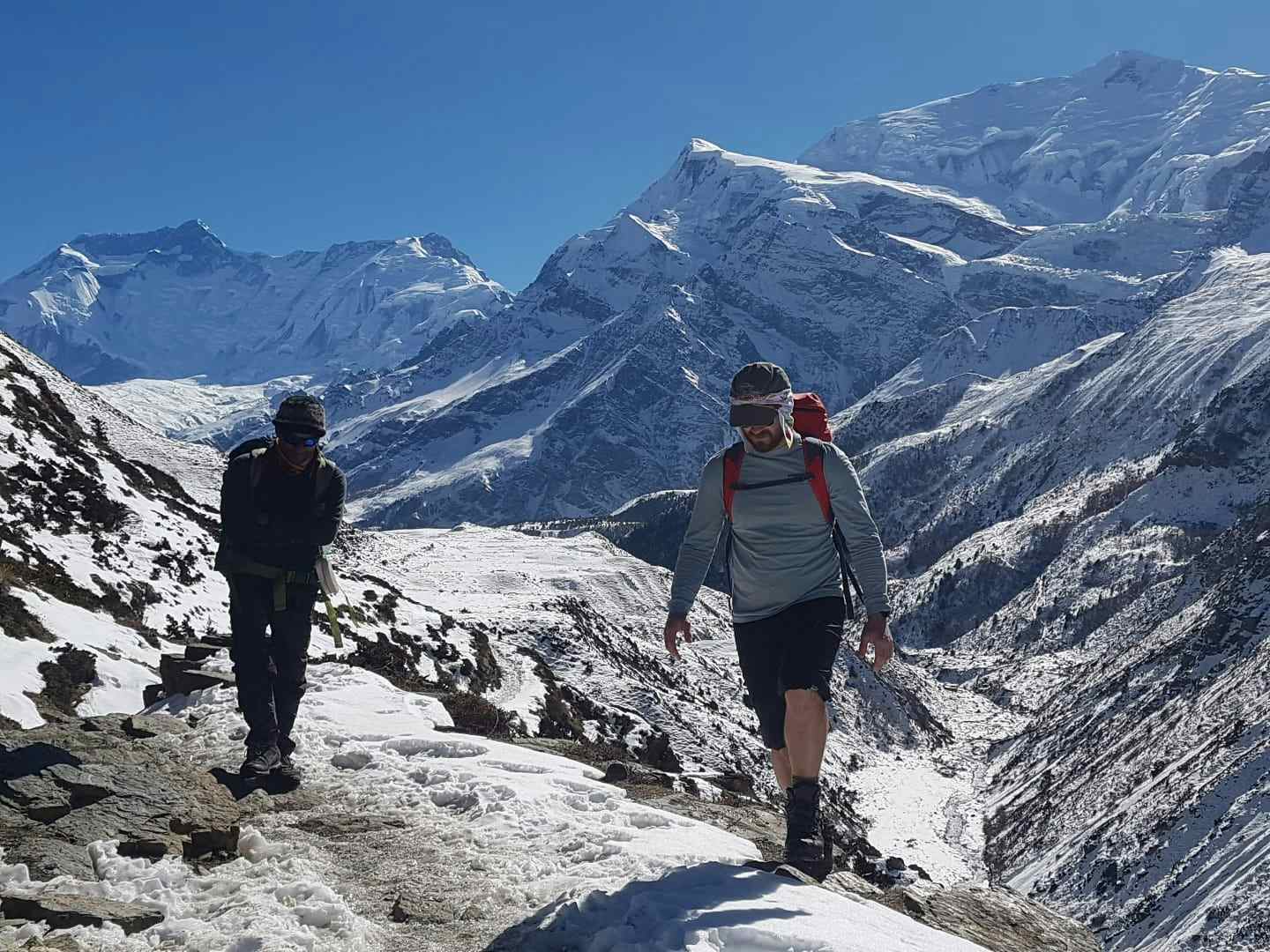 Two hikers on the way to Thorung Phedi Base Camp, Nepal.