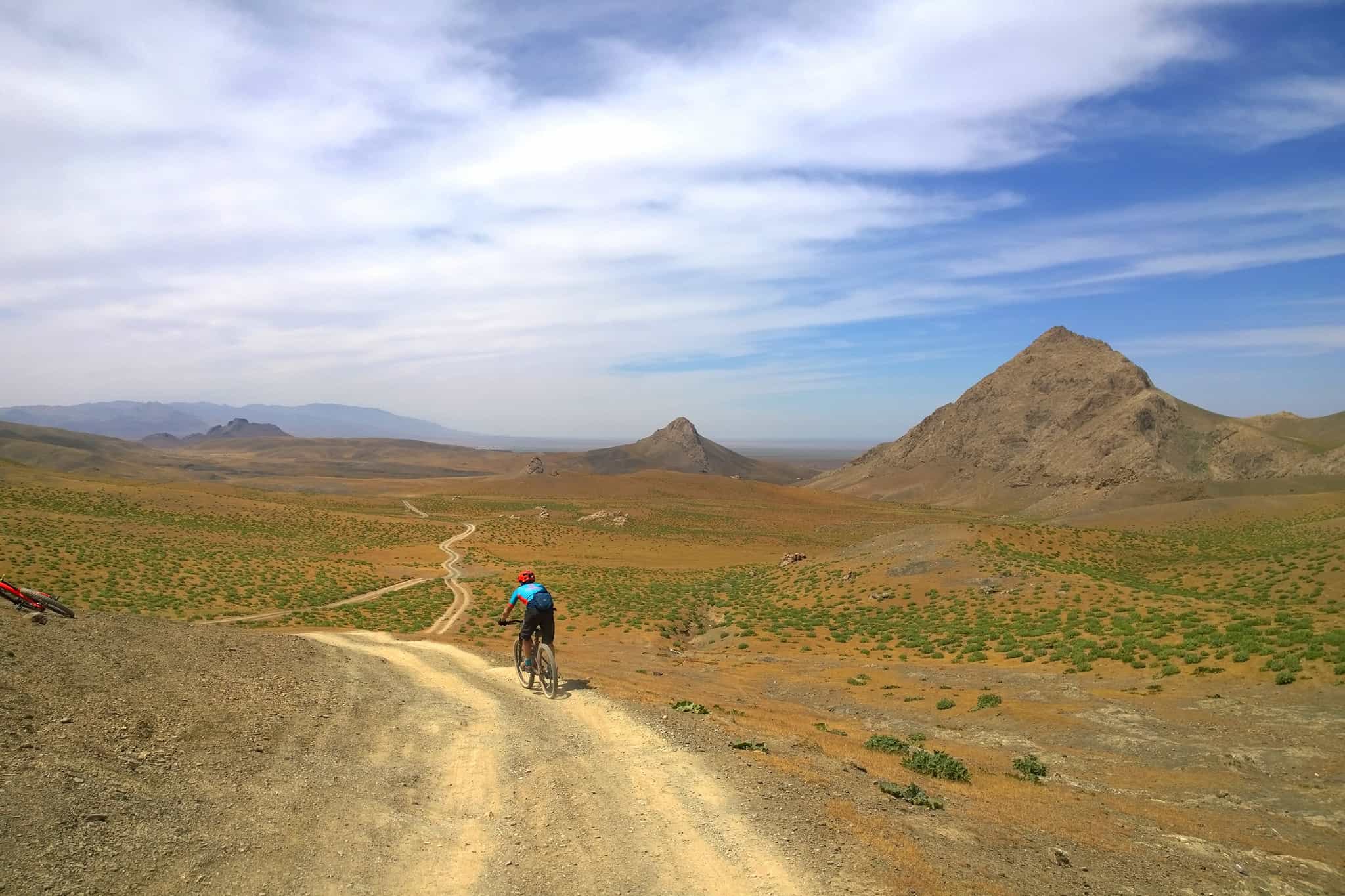 Cyclist riding the road to Ukhum in Uzbekistan.
