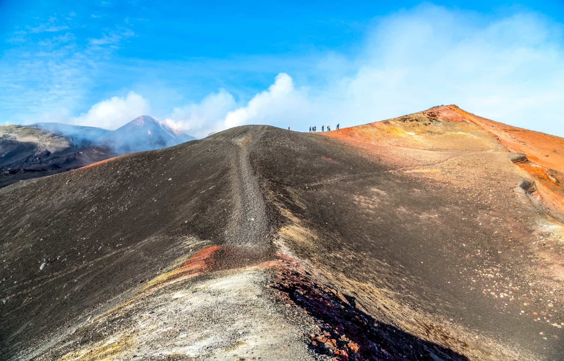 Hikers on the side craters of Mount Etna at 2800m, Sicily.