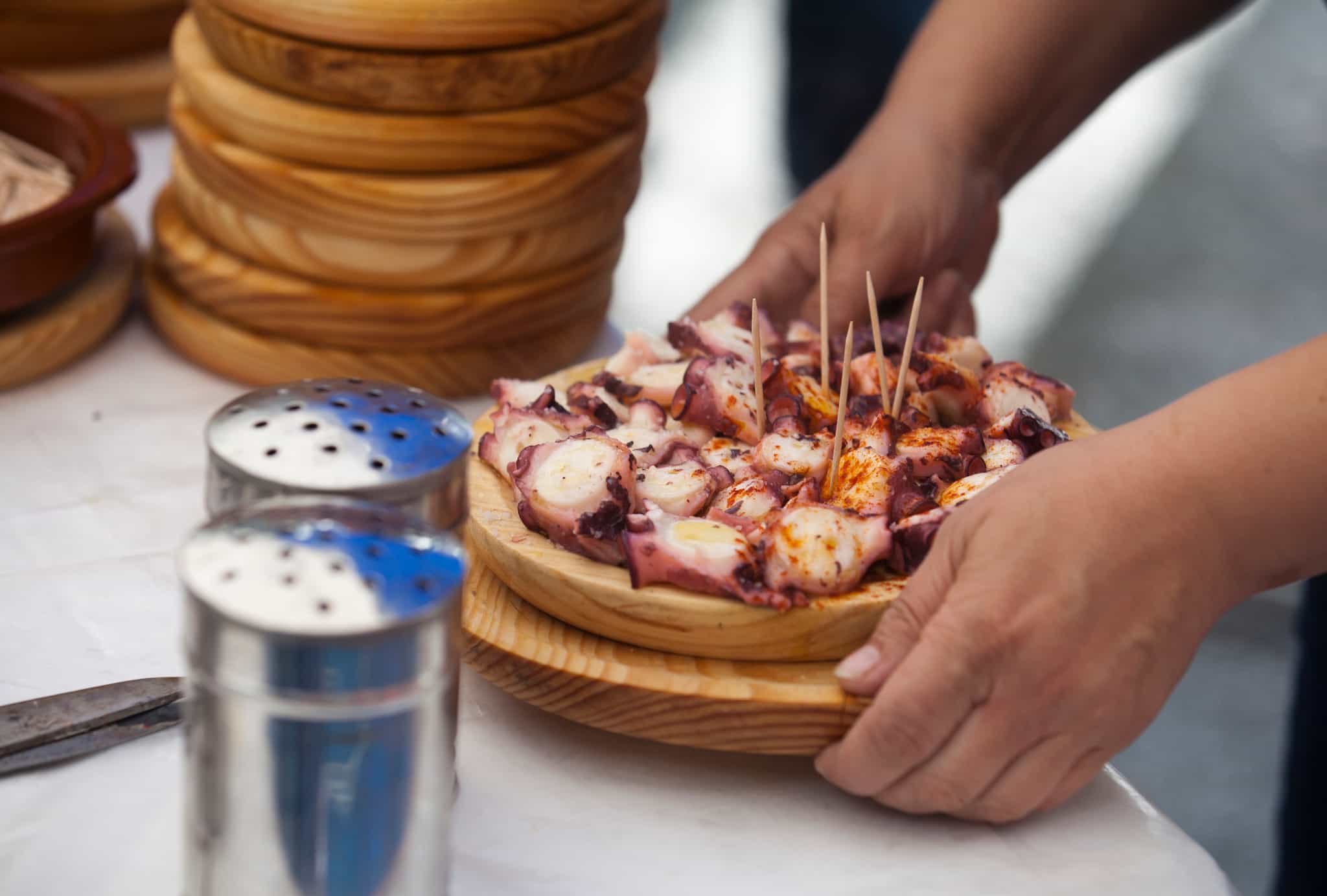Preparing and serving the famous dish Pulpo in Galicia