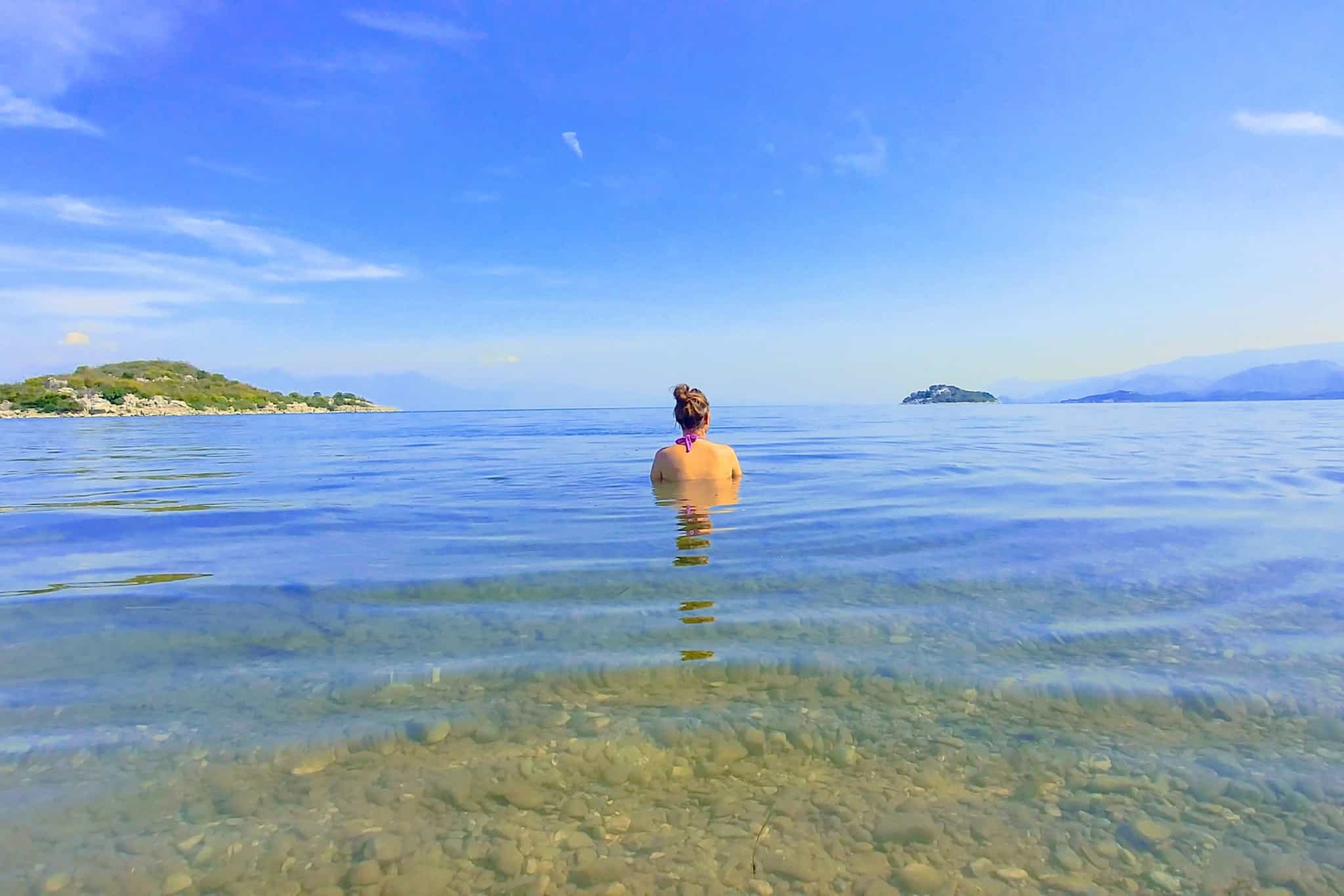 Woman swimming at Murici Beach on Skadar Lake, Montenegro.
