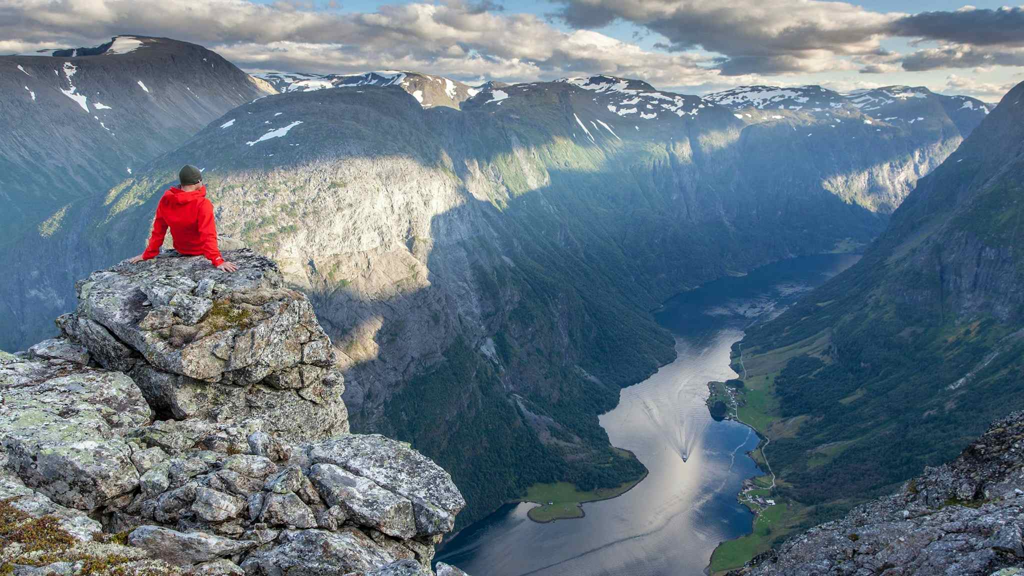 Sitting on a rock overlooking the fjord below