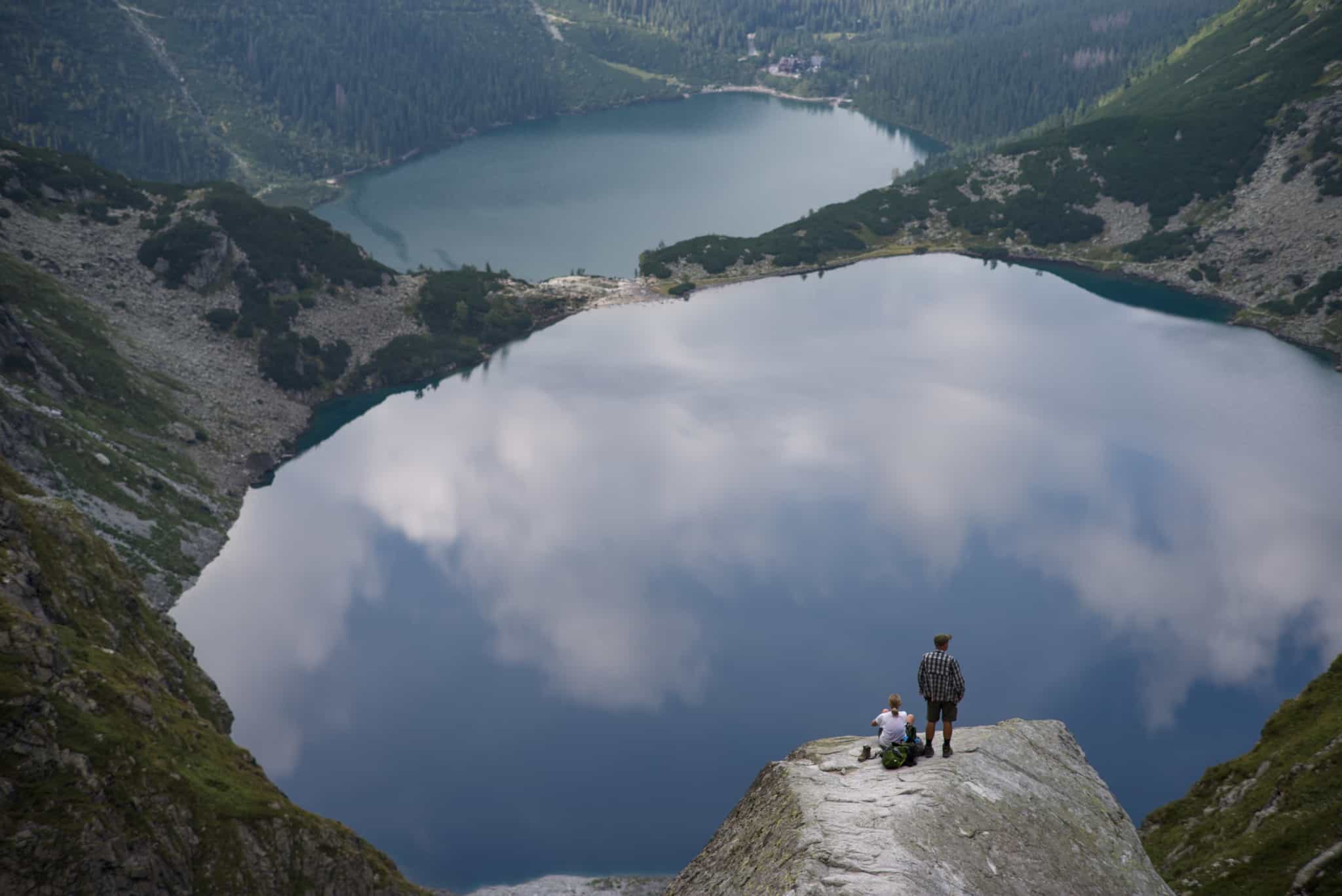 Hikers overlooking Czarny Staw lake in the Polish Tatra Mountains