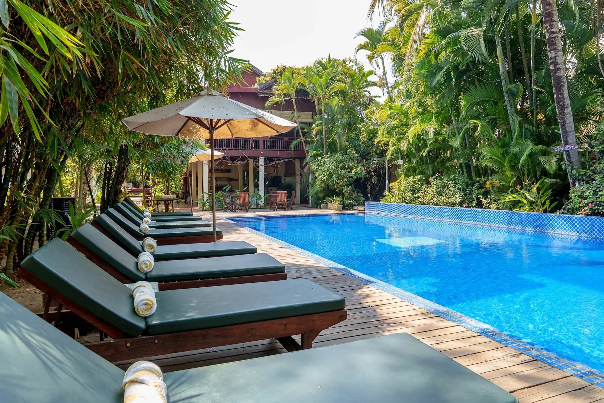 Outdoor pool and loungers at Sambor Village Hotel, Kampong Thom, Cambodia