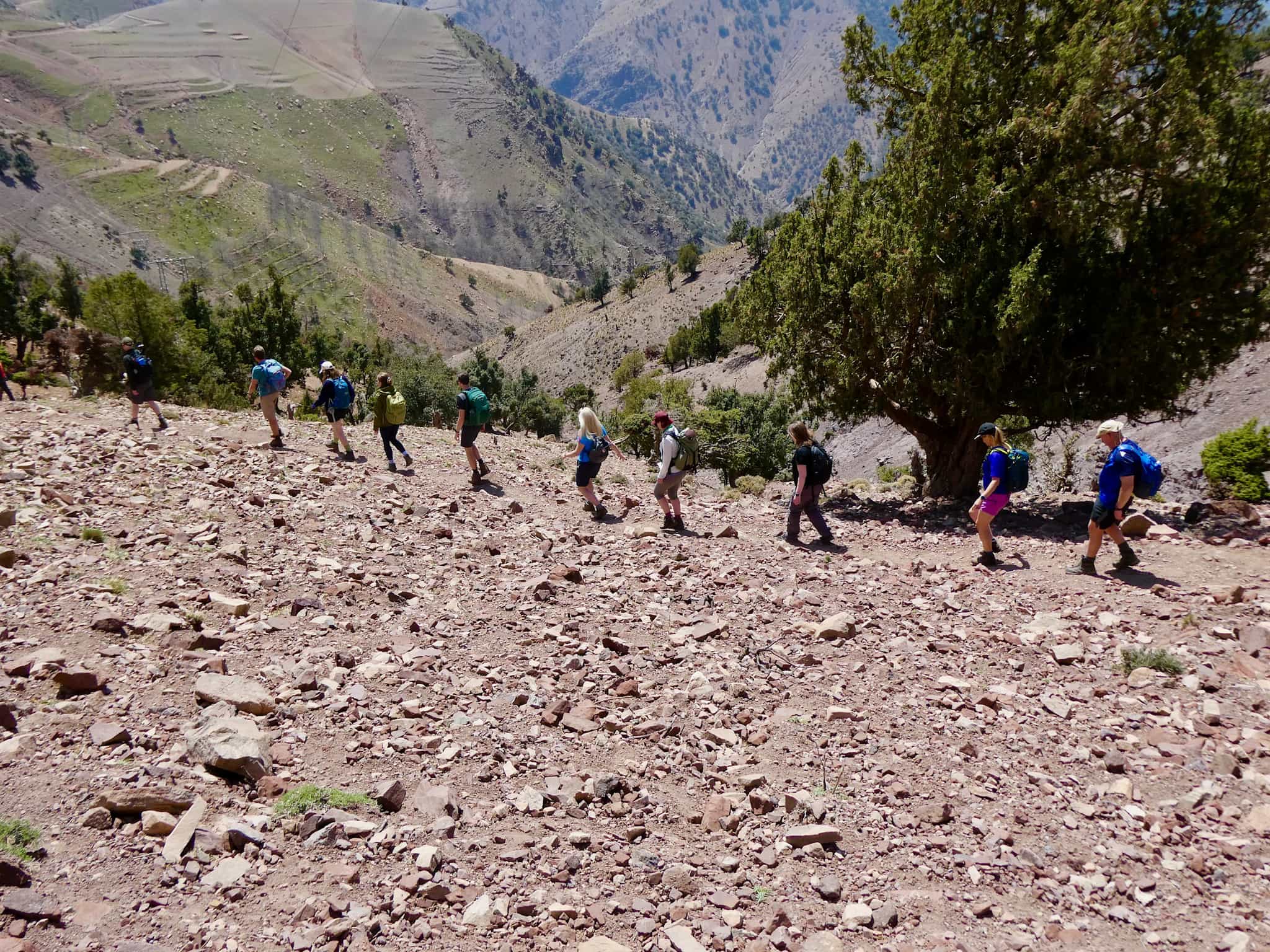 A group of people walking through the Atlas Mountains.