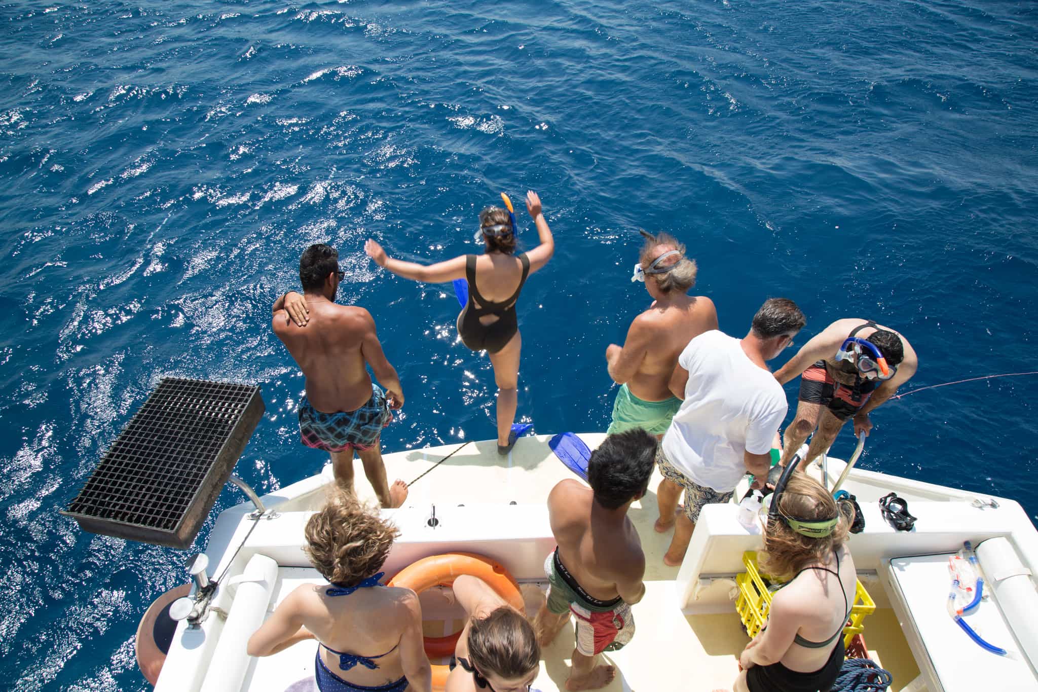 Travellers jumping into the Red Sea from a boat in Jordan.