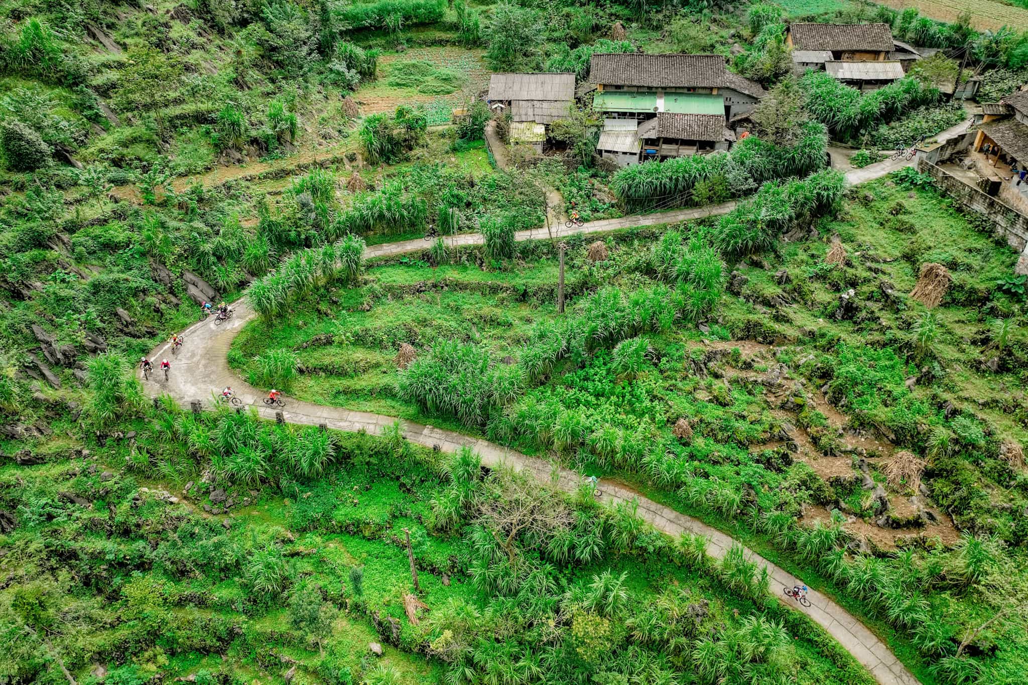 Aerial view of cyclists on a road in Ha Giang, Vietnam