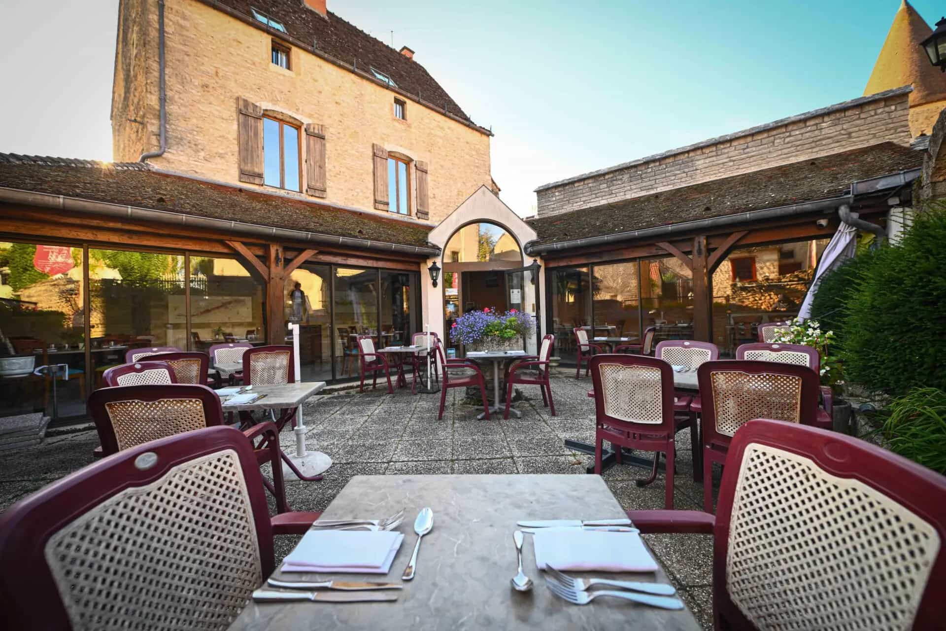 Outdoor dining courtyard at Hostellerie du Chateau, Châteauneuf-en-Auxois, France