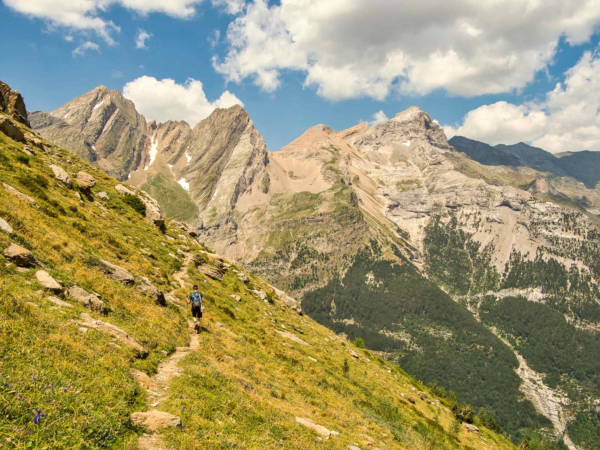 A man walks among the mighty mountains of Valle de Pineta in the Spanish Pyrenees. Photo: GettyImages-1308912316