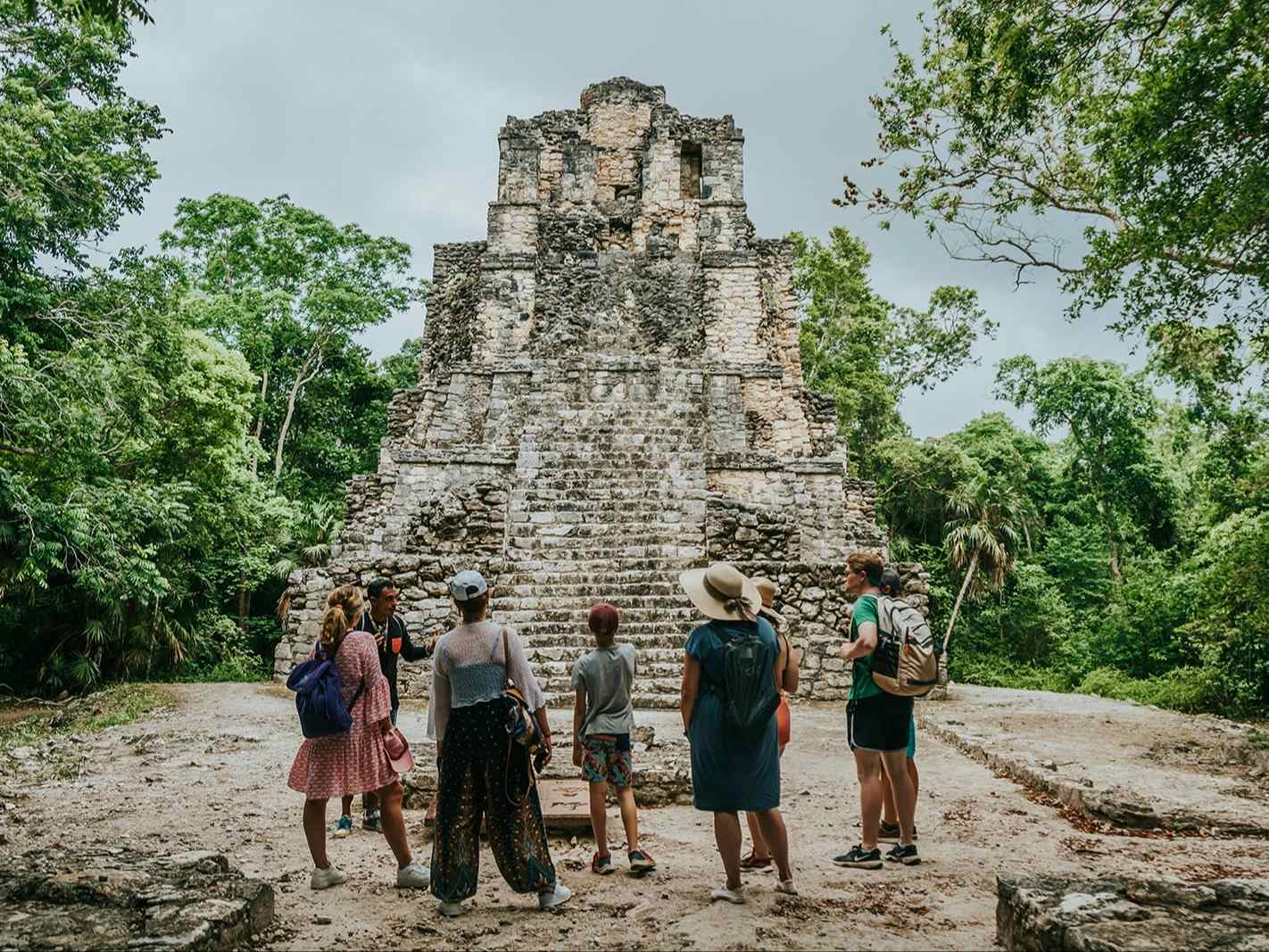 A group standing in front of the Muyil Mayan Ruins, in Sian Ka'an biosphere reserve, Mexico. 