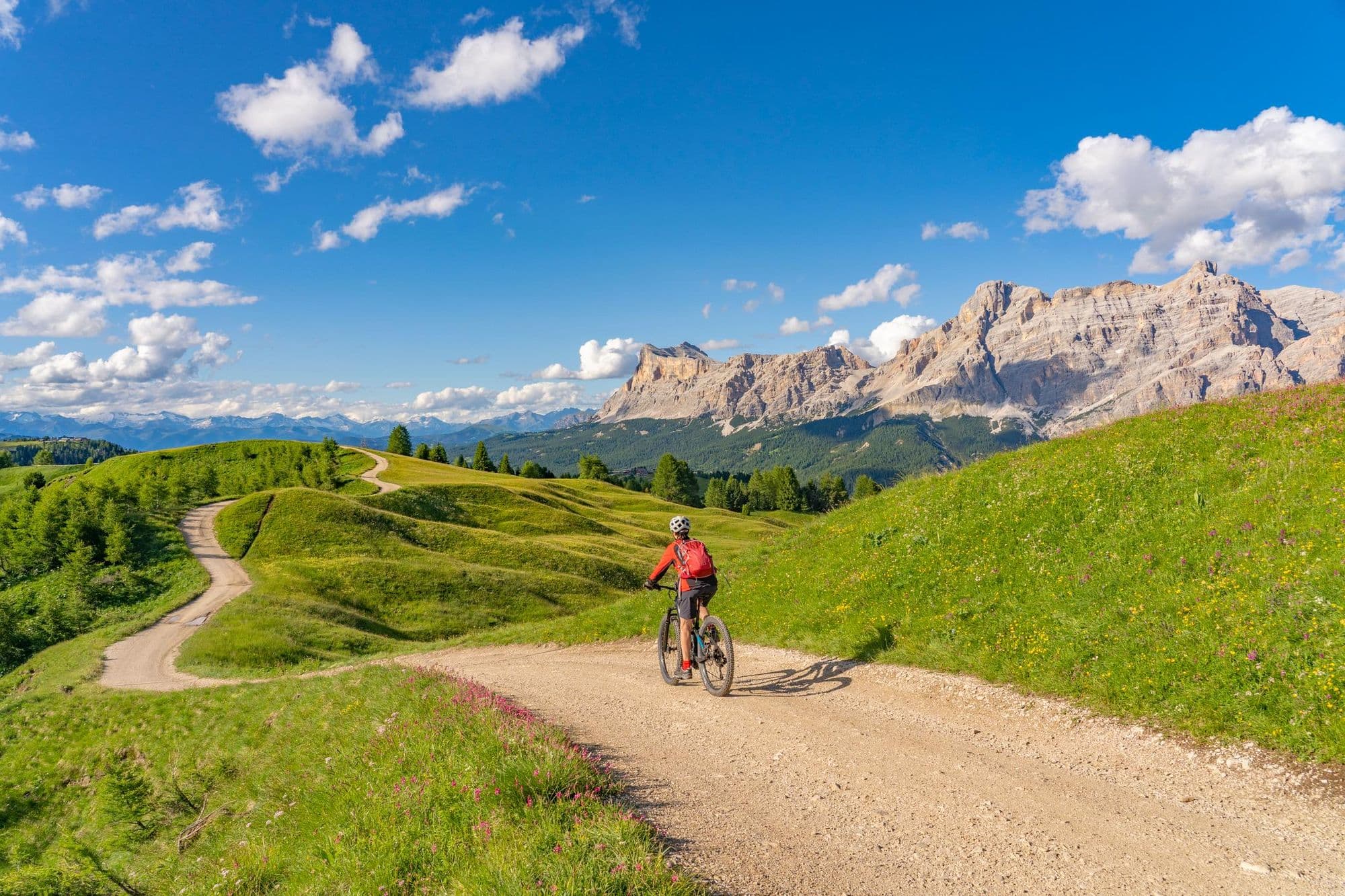 A solo cyclist riding through the Dolomites