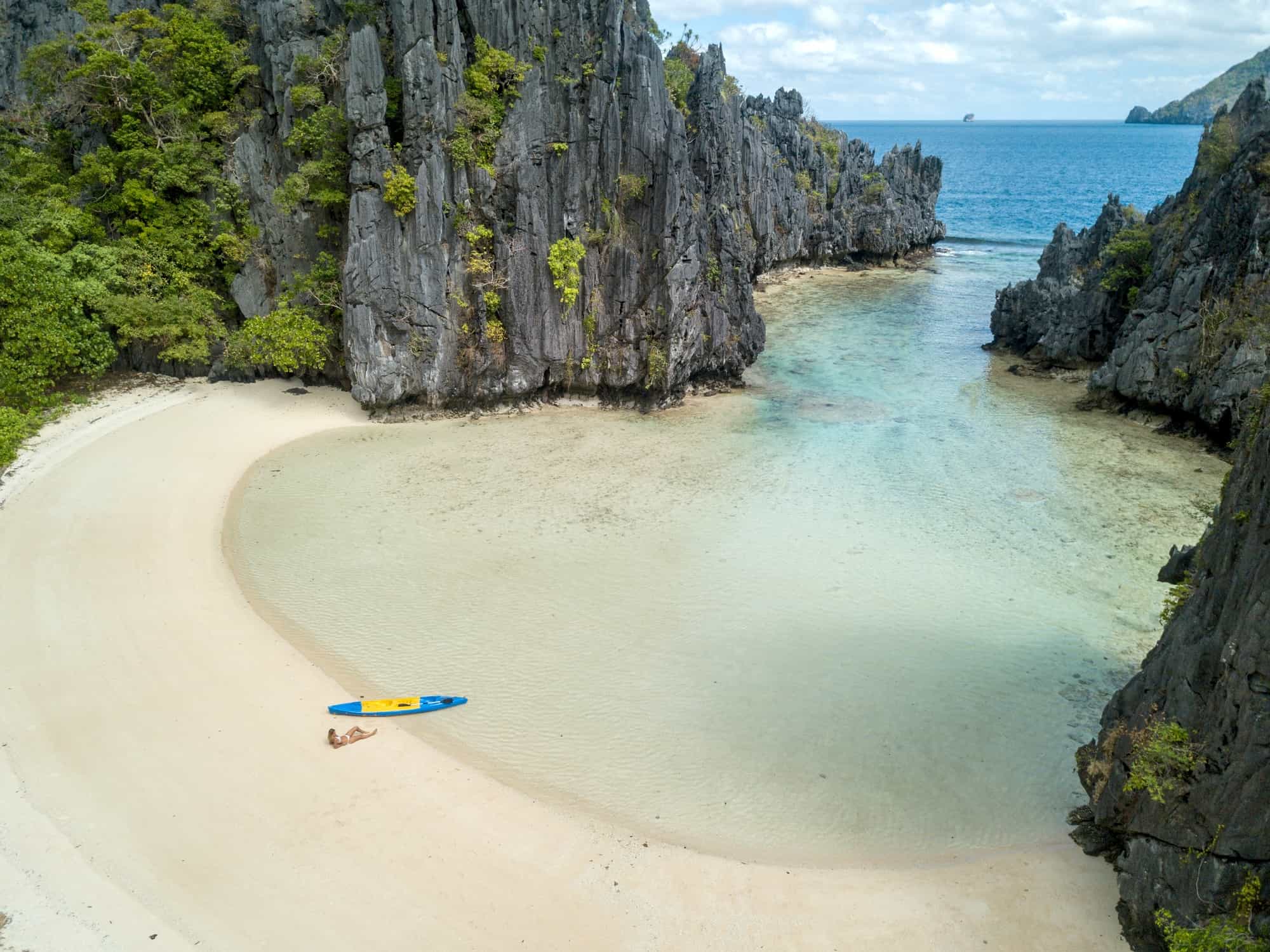 Aerial view of a paddleboarder relaxing on tropical beach in the Philippines