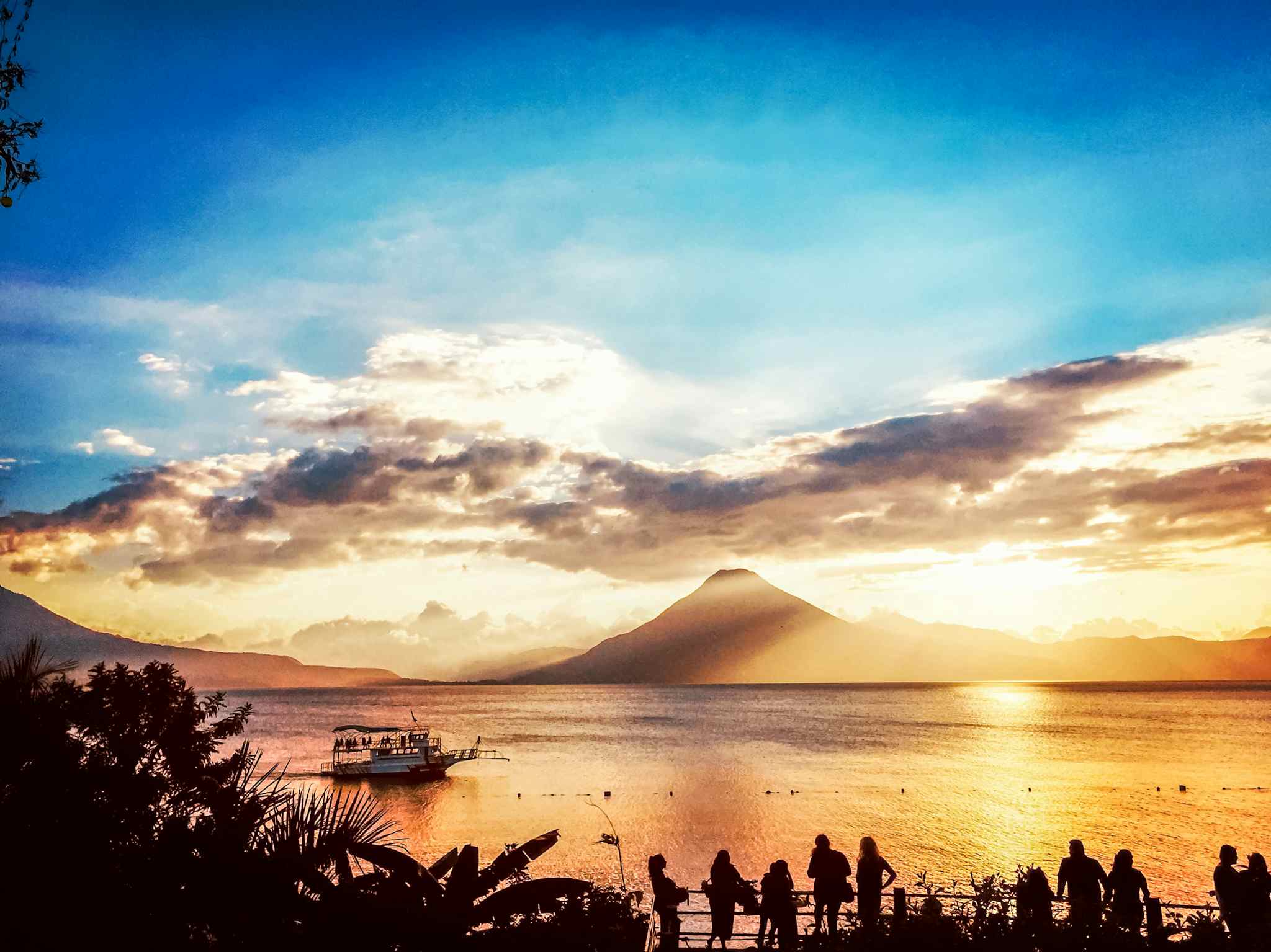Lake Atitlan with beautiful sunset colours and the silhouette of volcanoes in the background, Guatemala.