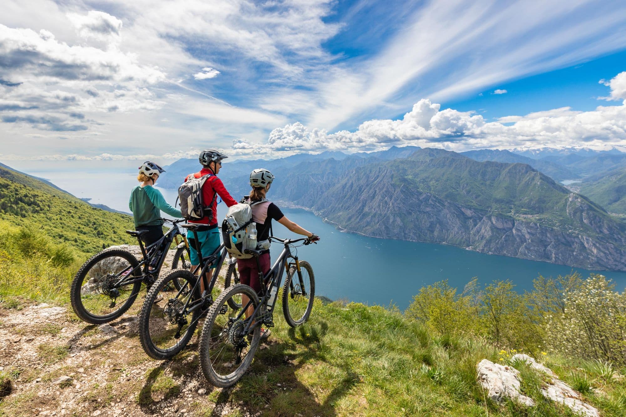 A group of cyclists stop and take in the view of Lake Garda