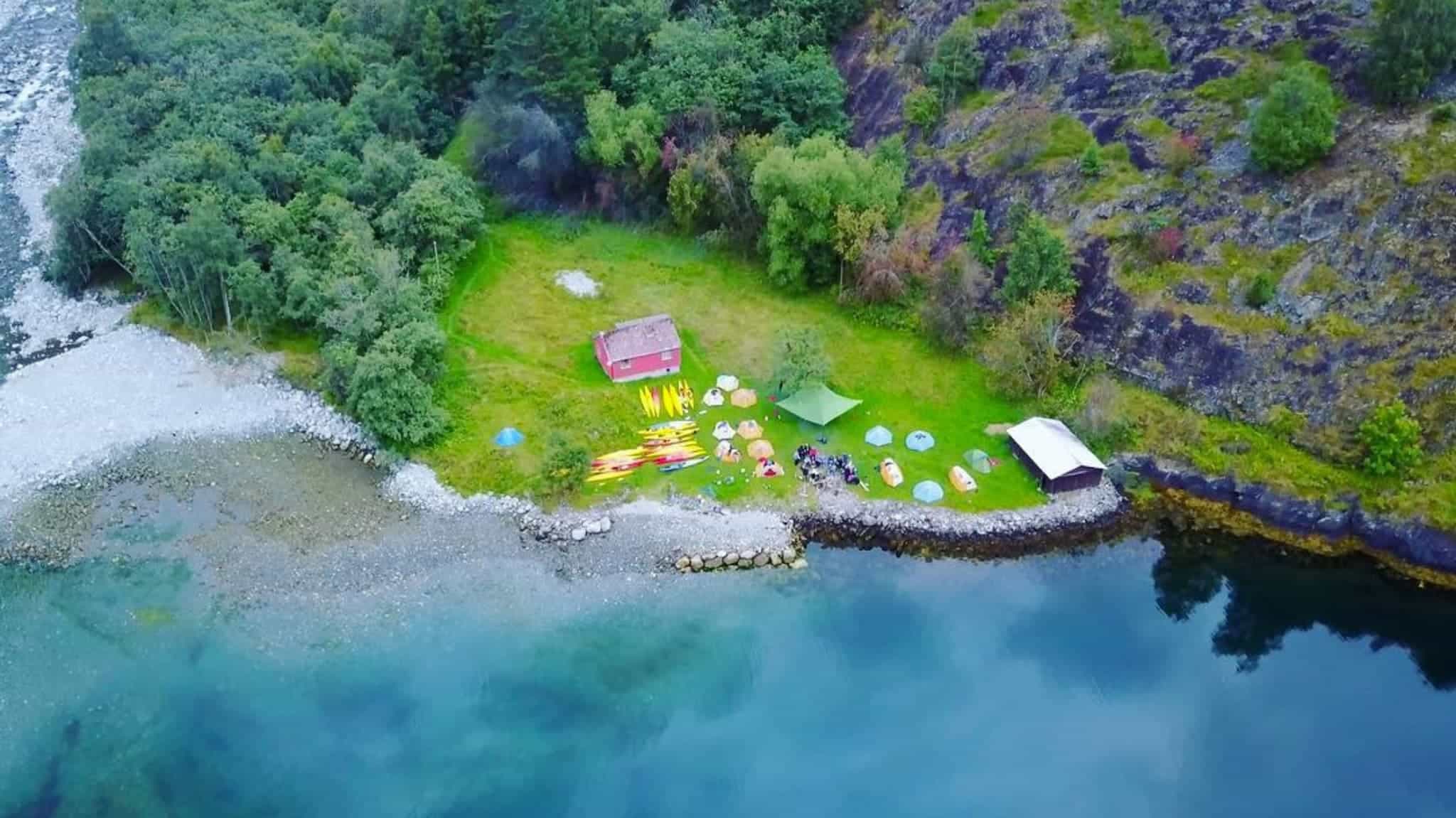 Aerial shot of camp at fjords edge.