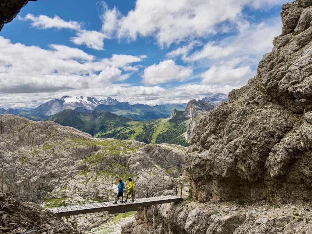 Hikers crossing a bridge ahead of the Ferrata Lagazuoi in the Italian Dolomites.