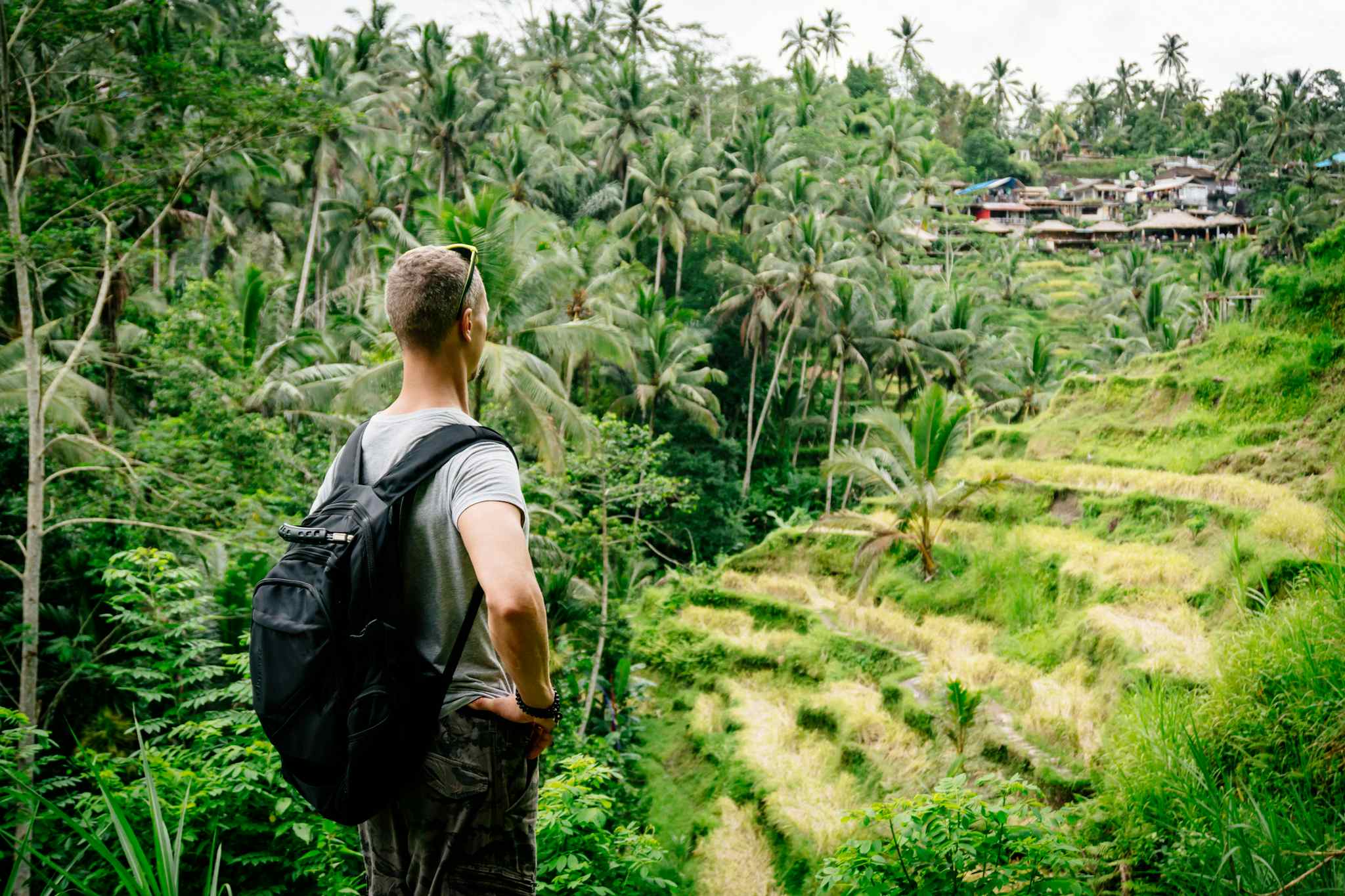 Man hiking through plantations in Bali, Indonesia. 