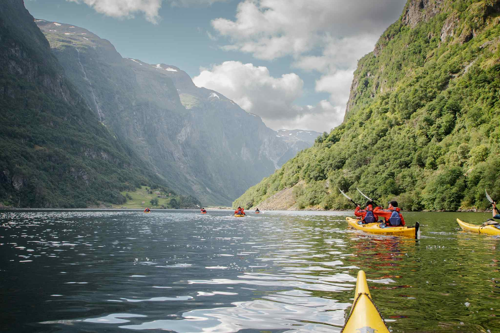 Kayakers paddling along the Nærøyfjord in Norway.