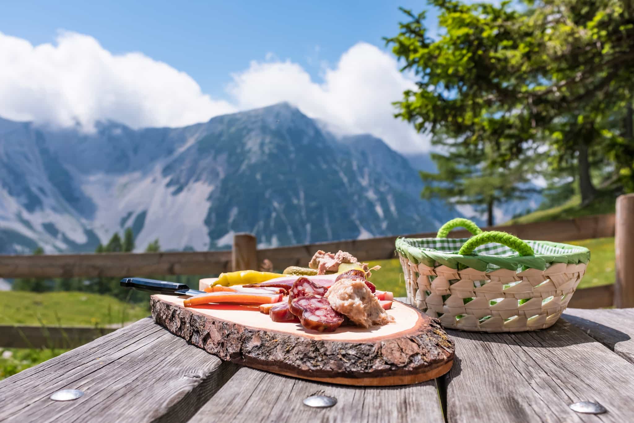 Picnic lunch of meat, vegetables and bread in the mountains