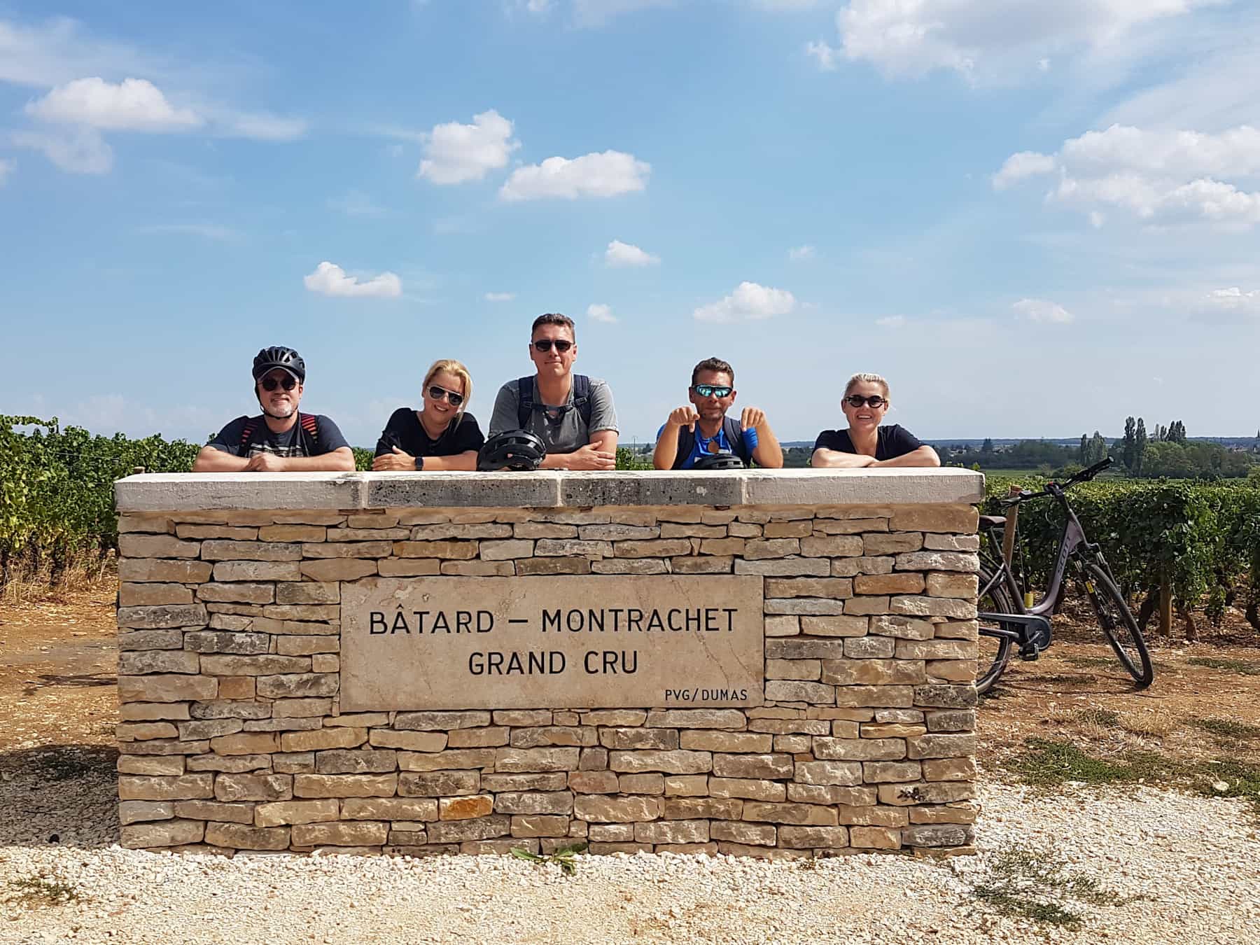 Group by vineyard sign, stoped for tasting whilst cycling through Burgundy France