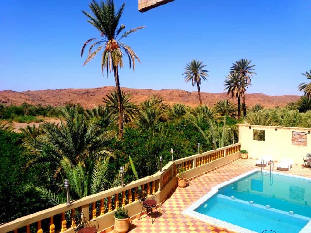 View overlooking a pool and palm trees, Kasbah Mahdaoui, Skoura, Morocco