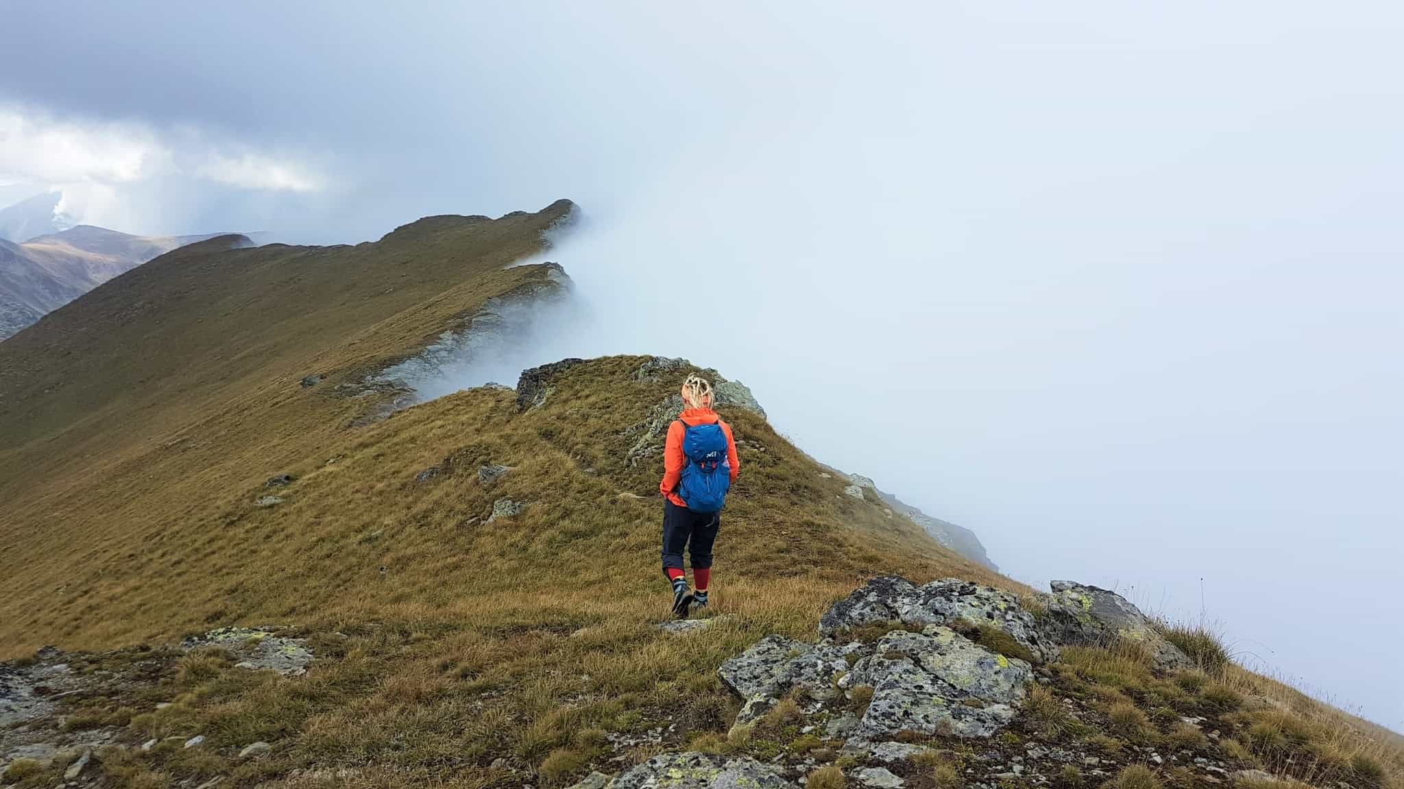 Woman hikes along the ridgeline