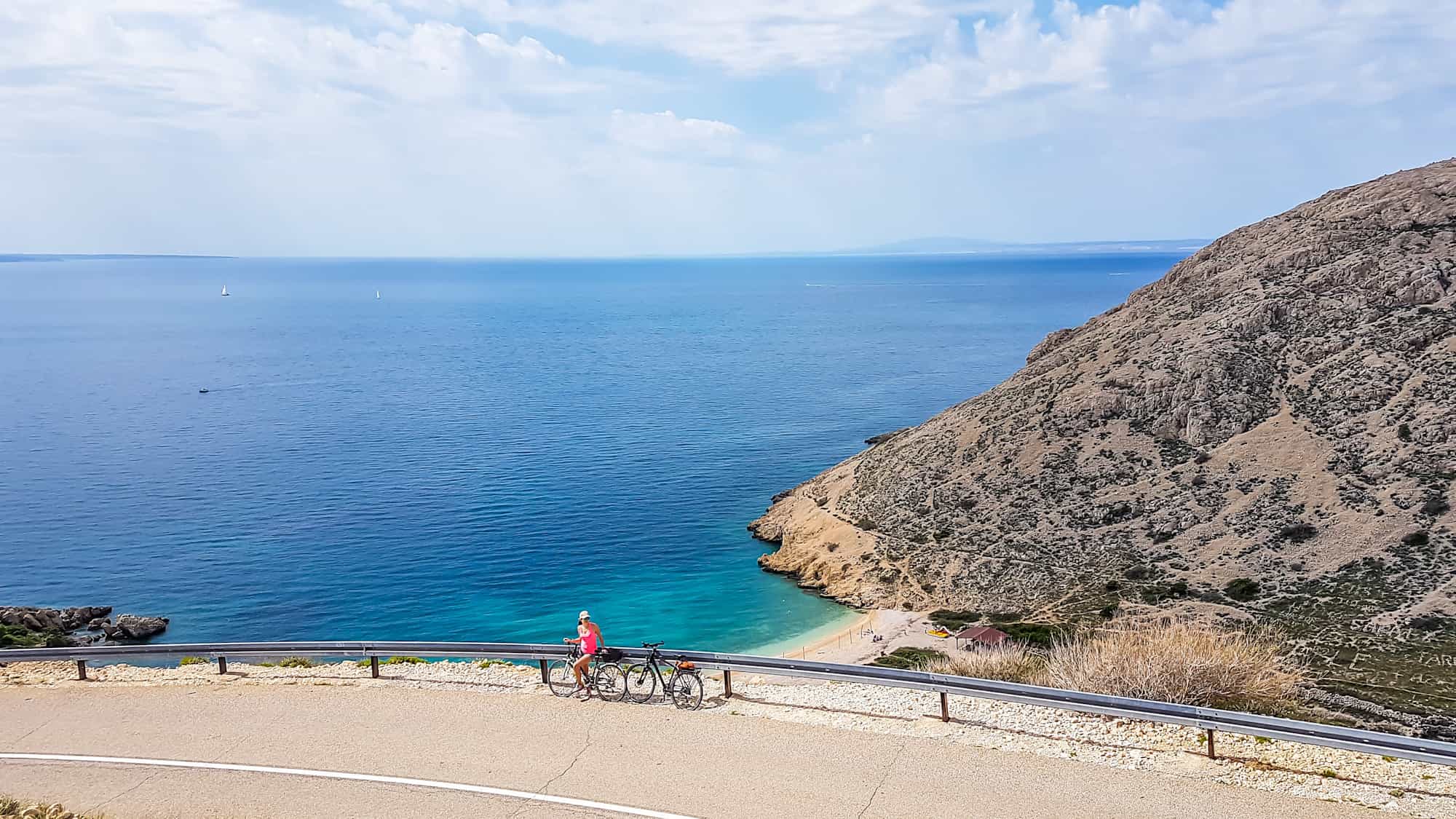 Feamle cyclist enjoying the bay view from the hill, Croatia
