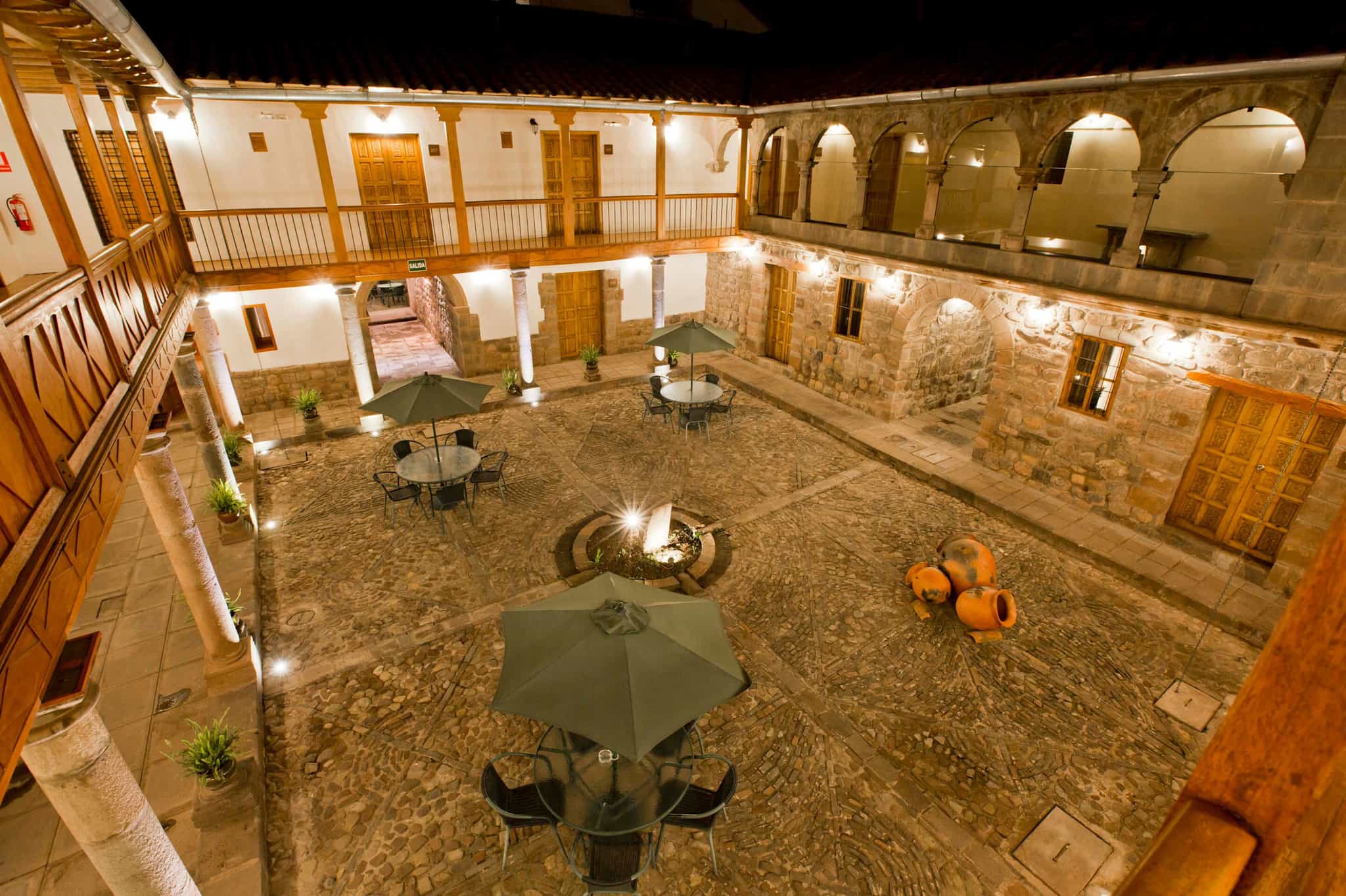 The internal courtyard of the Tierra Viva Centro Hotel, Cusco, at night.