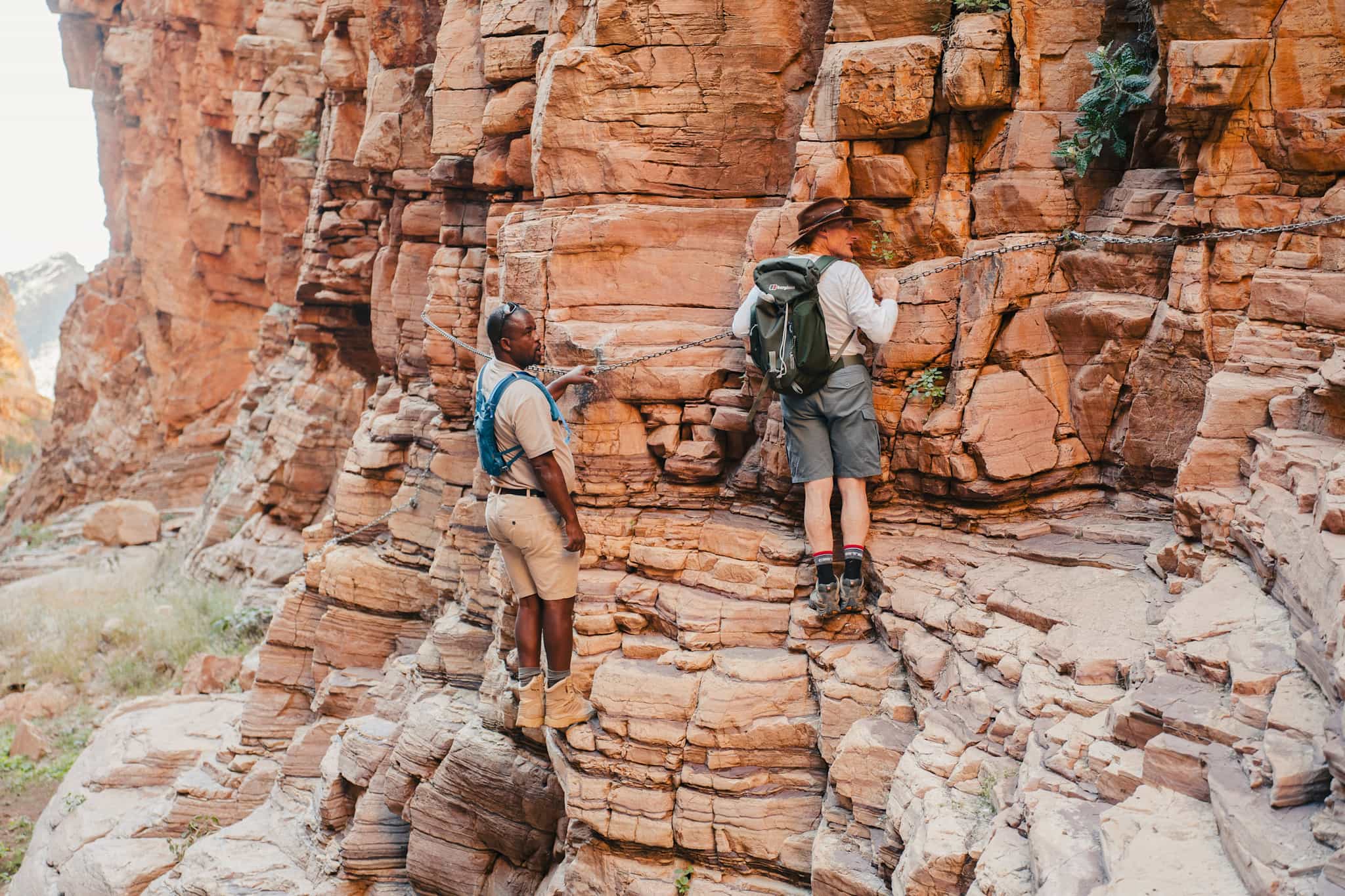 Hikers navigating a fixed rope section on the Olive Trail, Namibia.