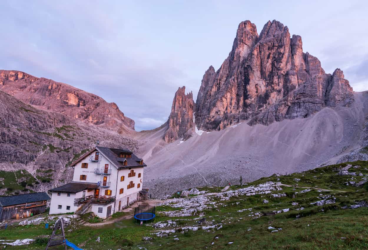 The Zsigmondy alpine hut near the mountain Zwoelferkopf in the Dolomites during sunset.