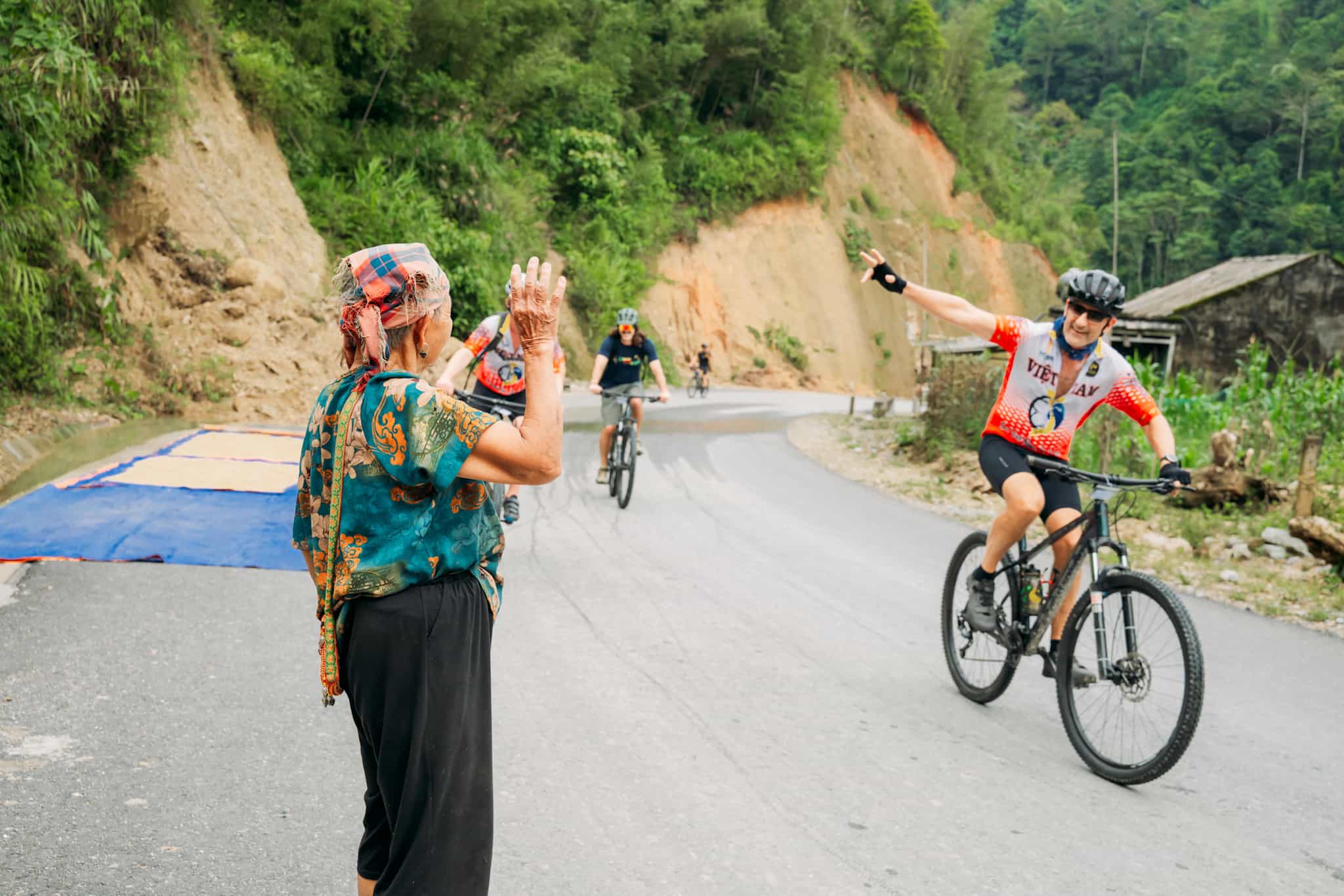 Cycling past locals in Hoang Su Phi, Vietnam
