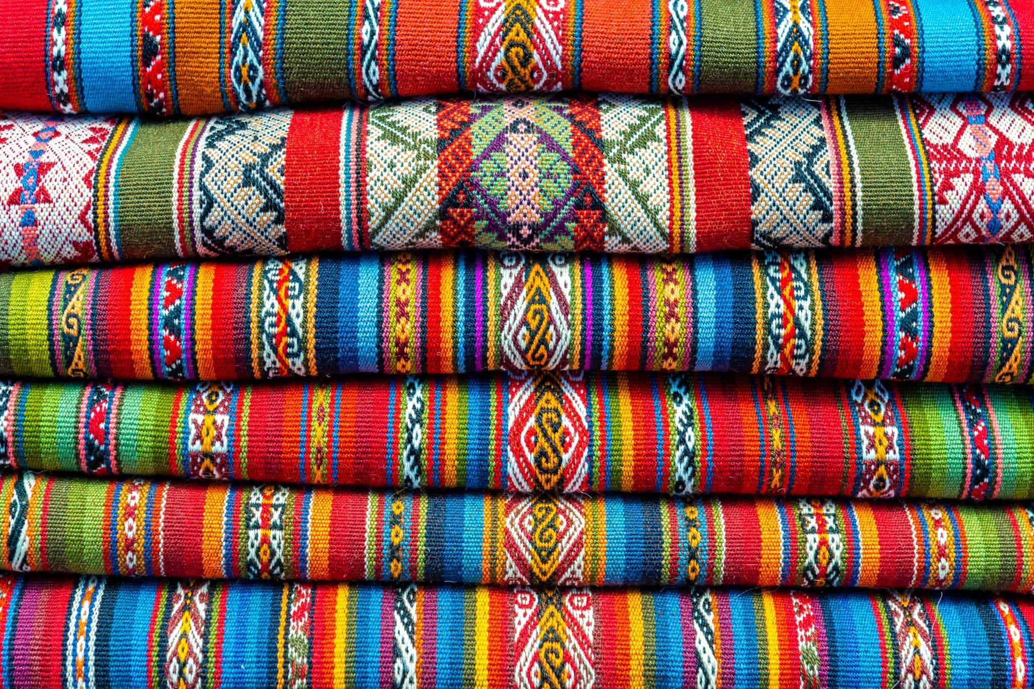 Colourful Andean textiles in Peru. Photo: Canva link:https://www.canva.com/photos/MAD5AIvSt6U-andes-textiles-cusco-peru/