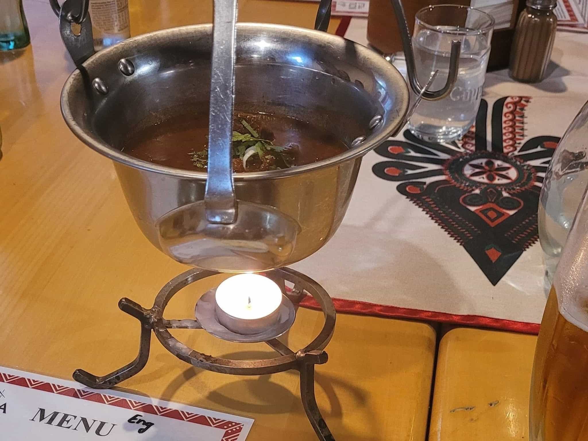 Slovakian stew warmed by a candle from below.