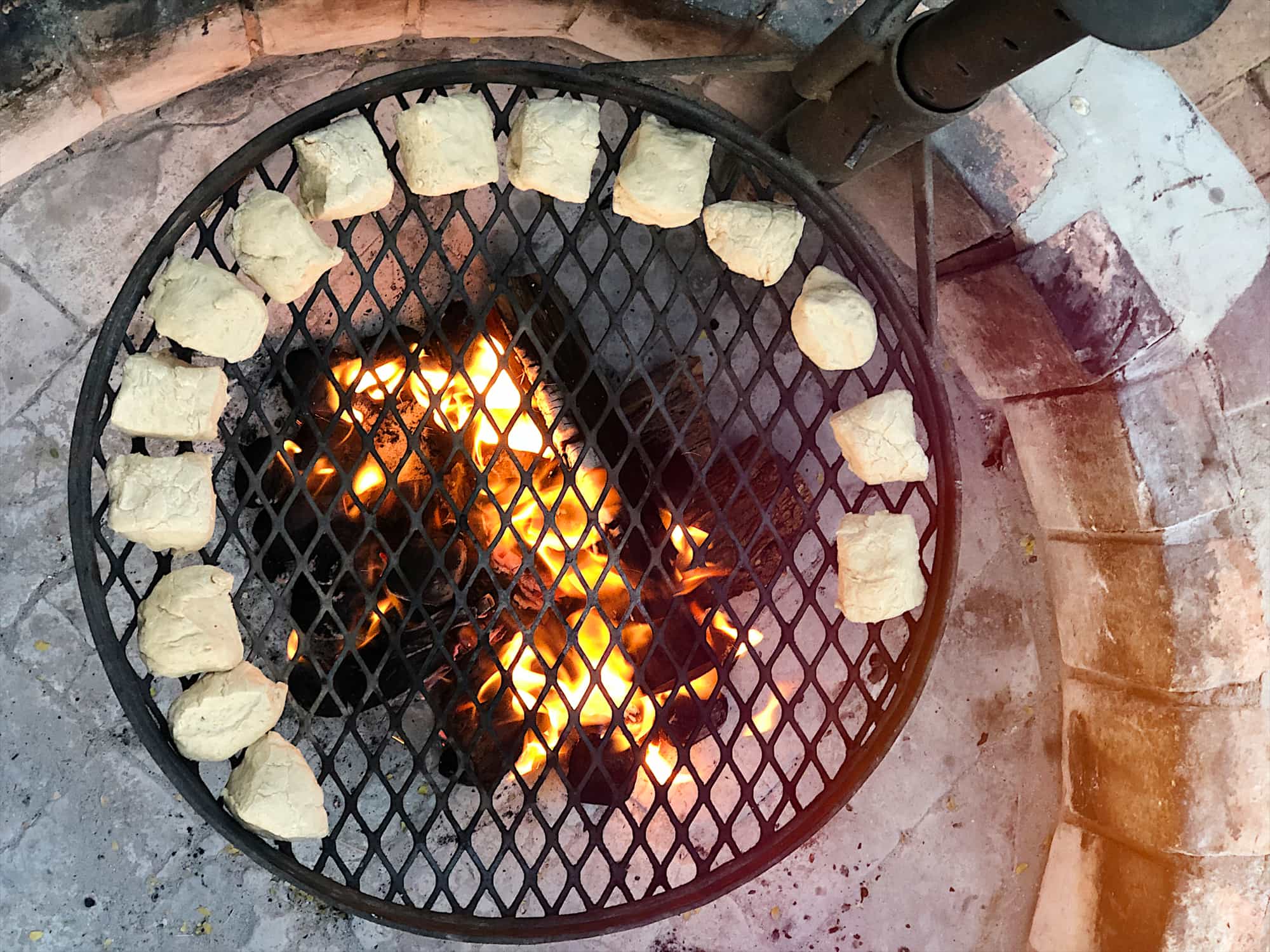 Cooking roosterkoeke dough bread on a fire pit in Namibia