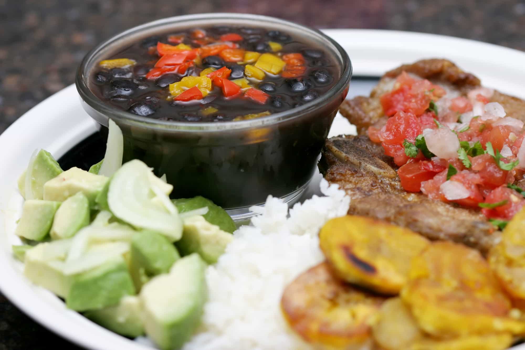 Cuban dinner consisting of rice, beans, plantains, and beef steak