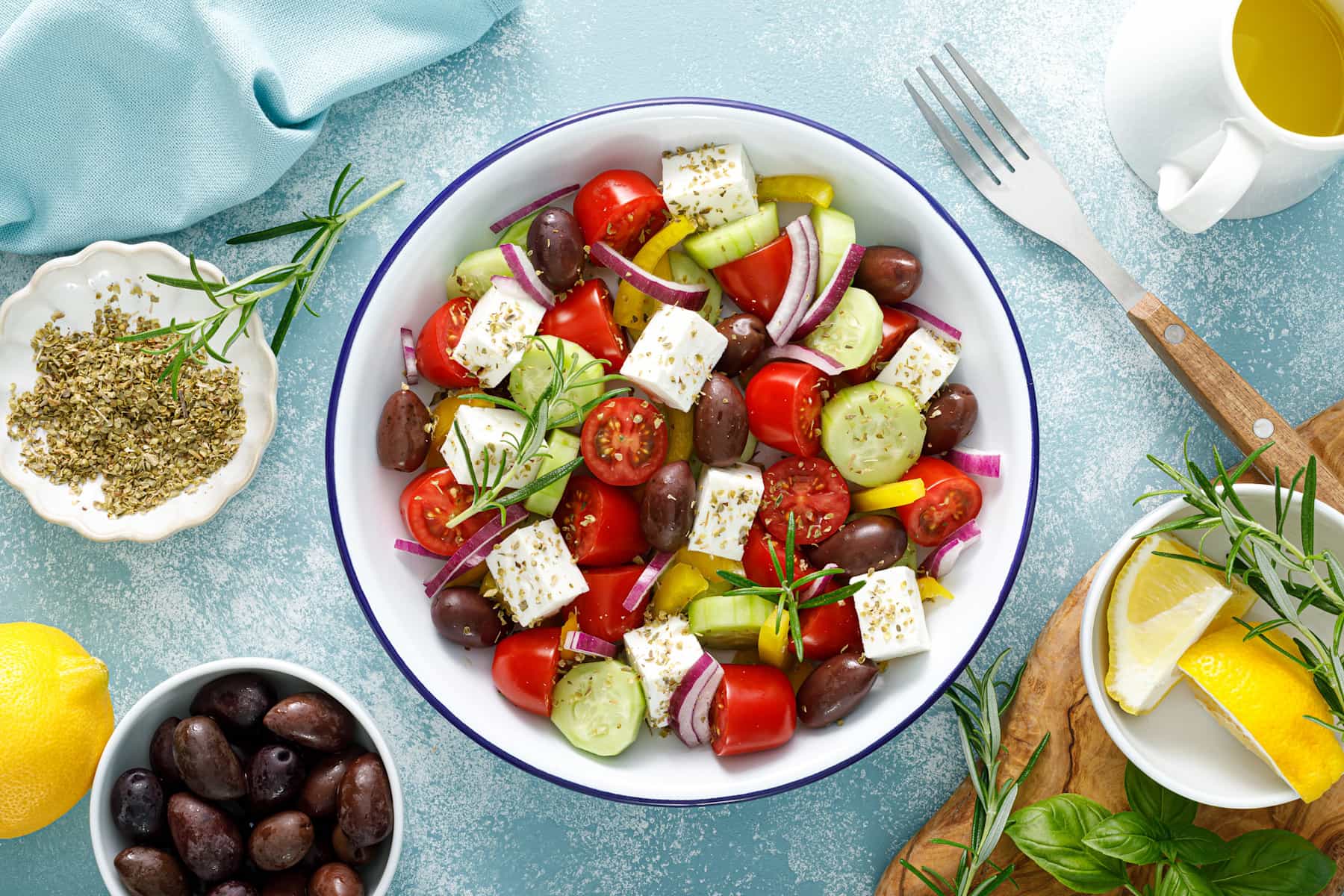 A table with Greek salad and olives