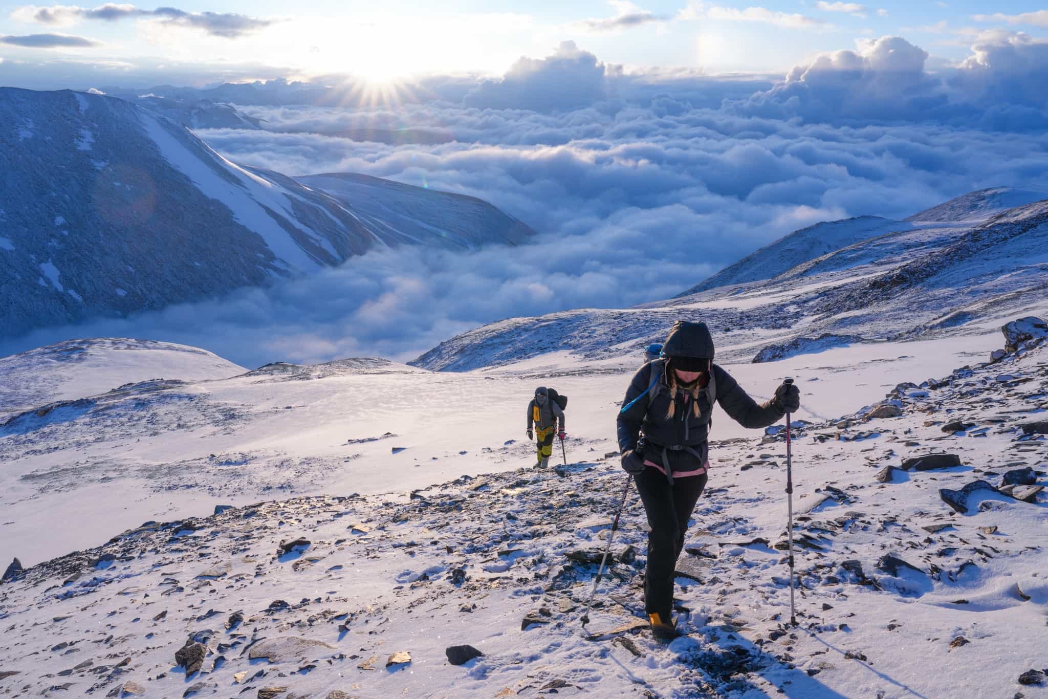 Climbers on the ascent to summit UT Kangri at sunrise.