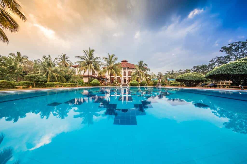 View across the swimming pool to colonial building, Hotel Yapahwa, Sri Lanka