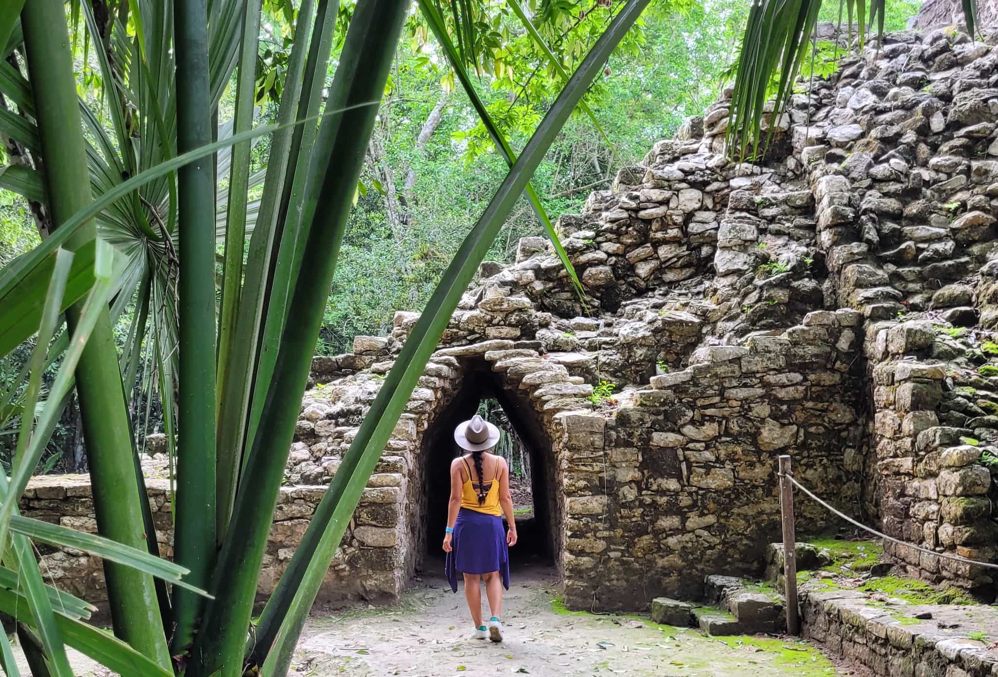 A tourist walking amongst the Mayan ruins of Coba, Yucatan, Mexico