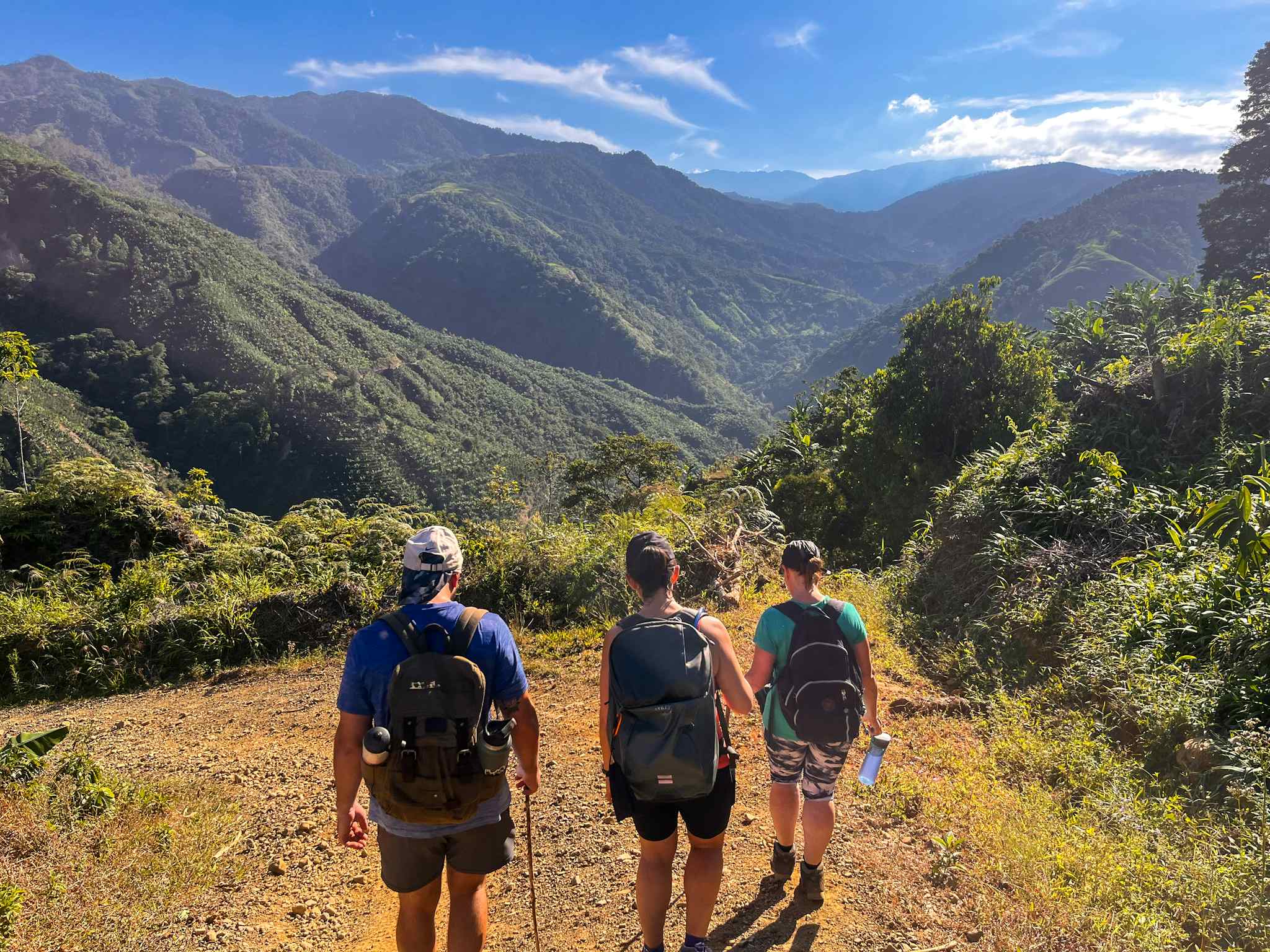 Trekkers ascending into the hills along the Camino de Costa Rica
