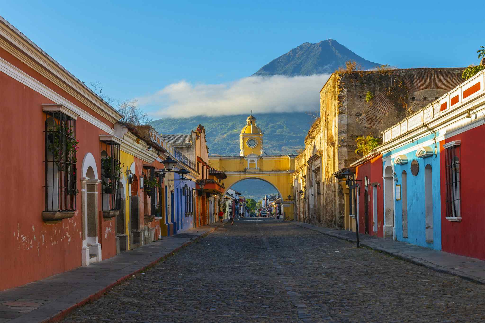 Santa Catalina arch in the historic centre of Antigua, with Agua volcano in the background, Guatemala.