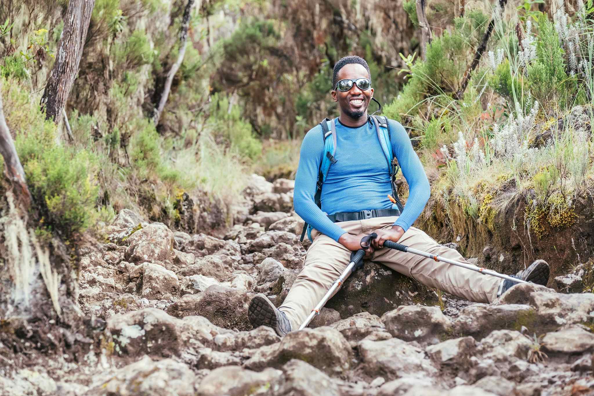 Hiker rests on the Rongai Route up Mount Kilimanjaro, Tanzania.