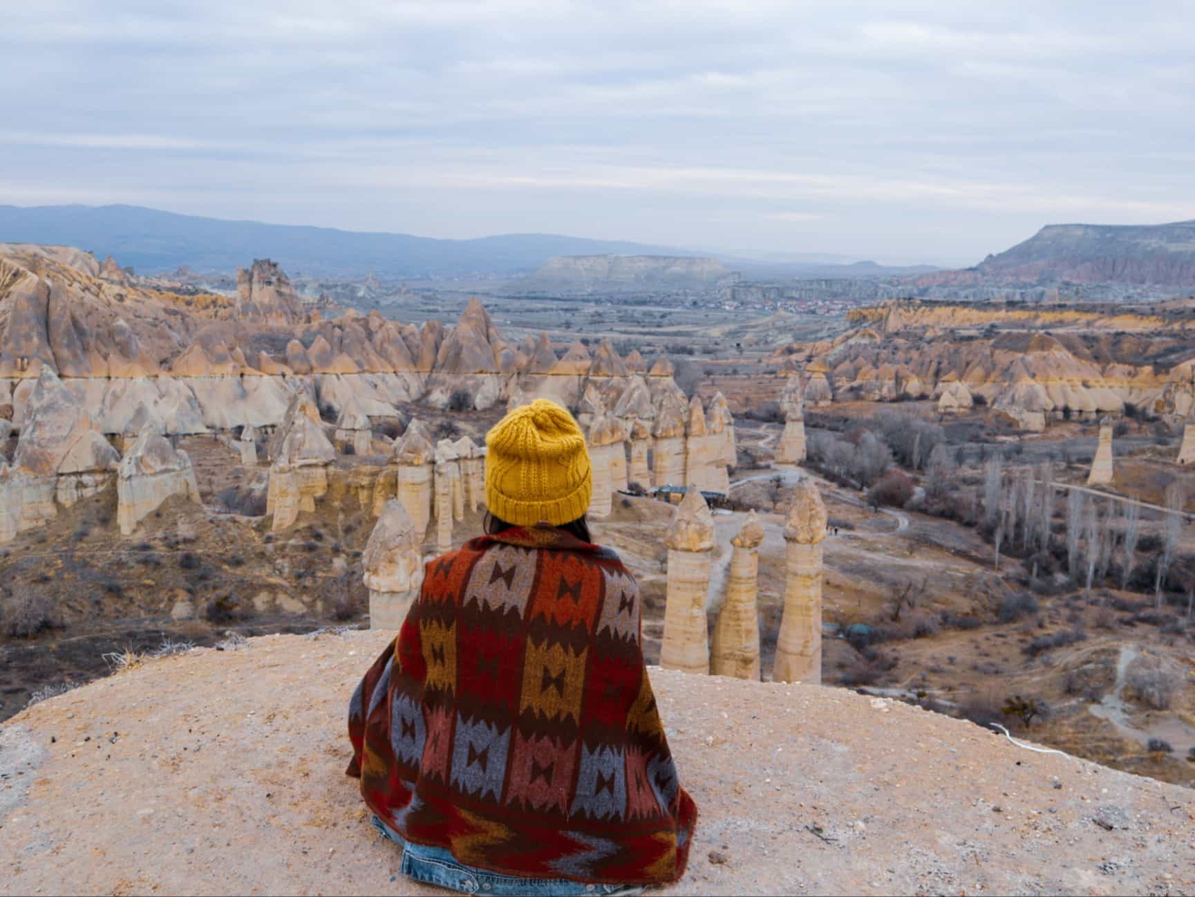 Woman watching the volcanic landscape at the Valley of Love in Goreme, Cappadocia.